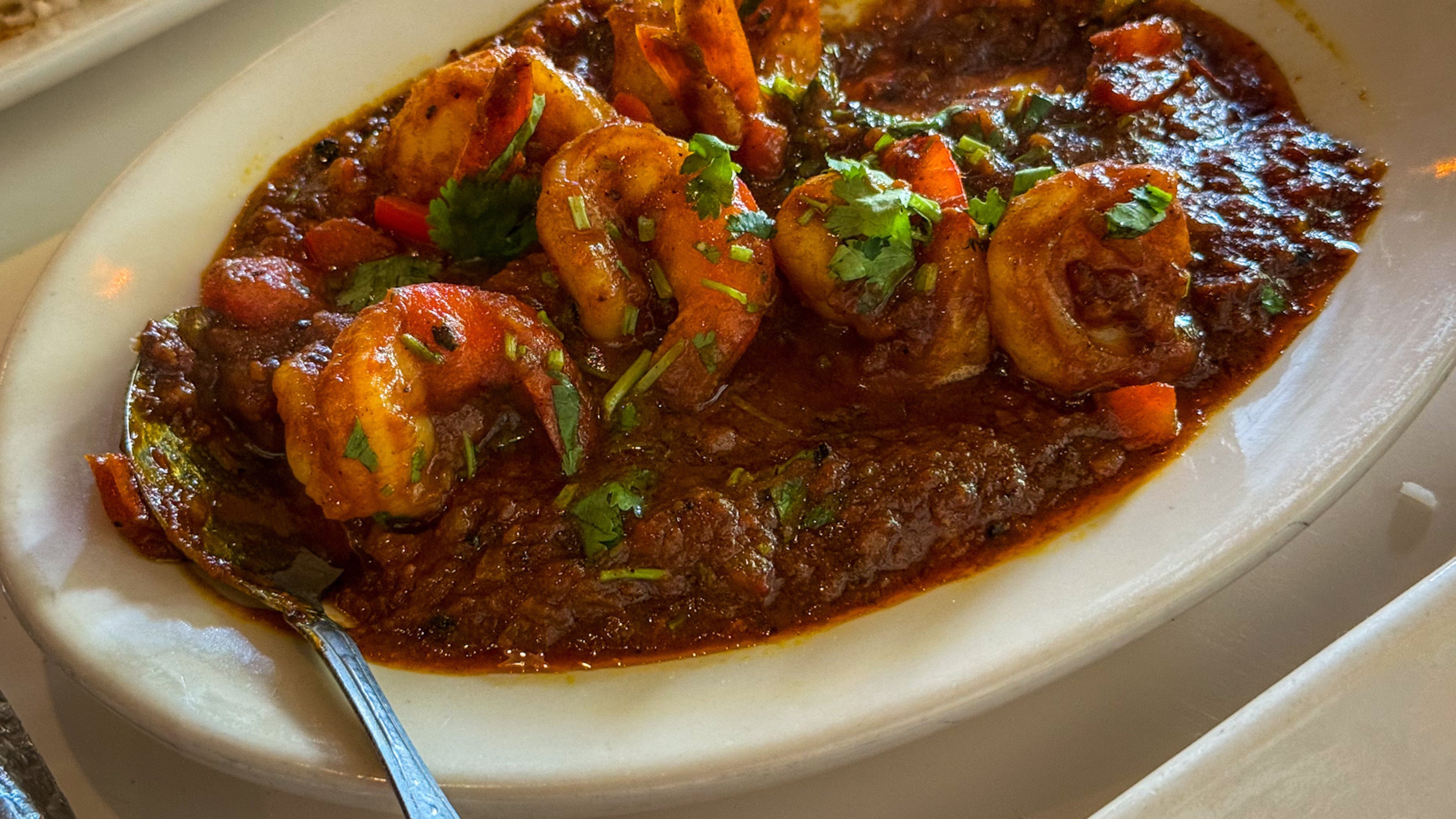 The bhagari shrimp at Ruchi Bangladeshi Cuisine were plump, properly cooked and served in a comforting tomato sauce. (Henri Hollis/AJC)