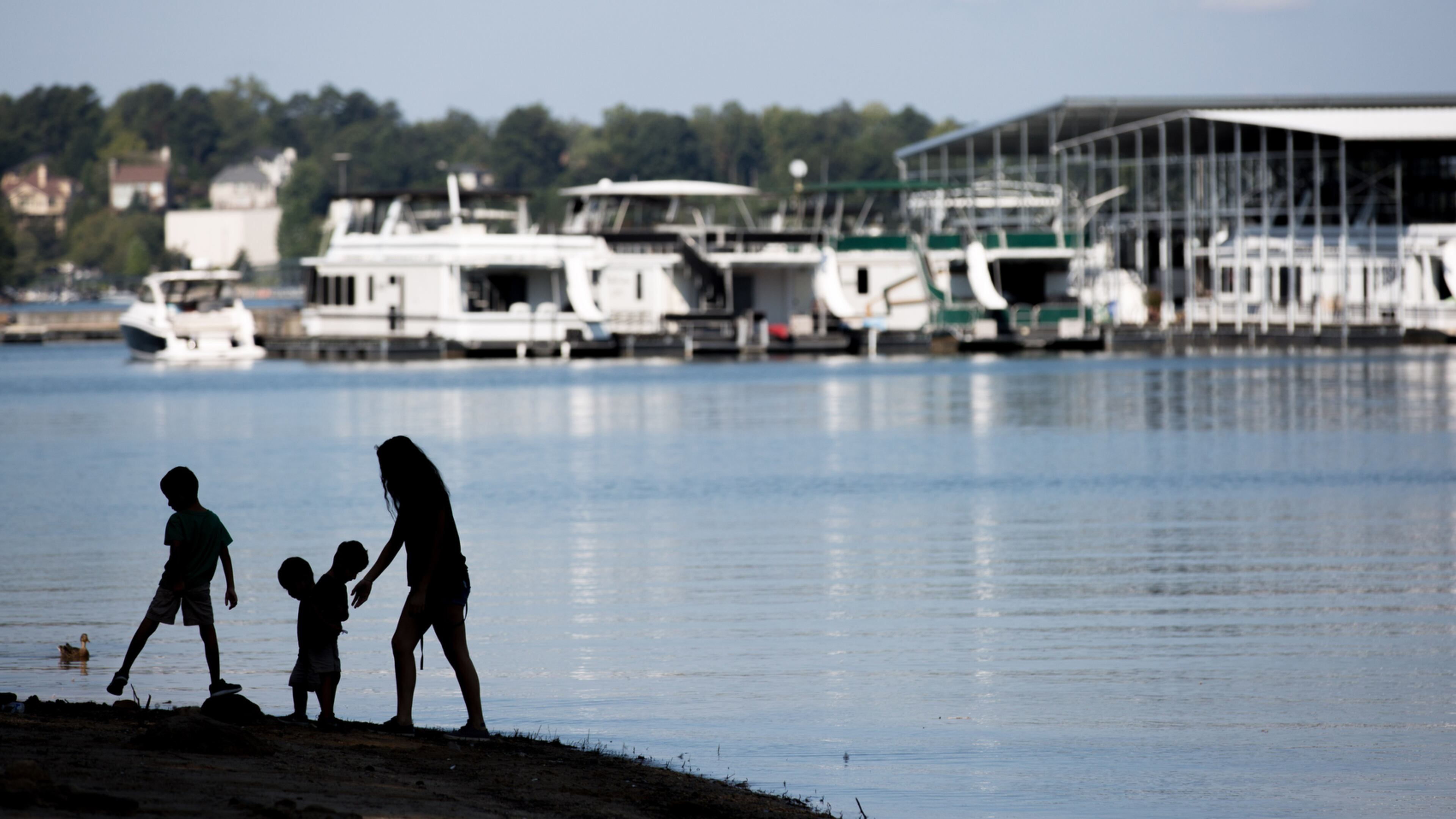 A family walks along the beach at Lake Lanier on Labor Day, Monday, Sept. 5, 2016, in Flowery Branch, Ga. BRANDEN CAMP/SPECIAL
