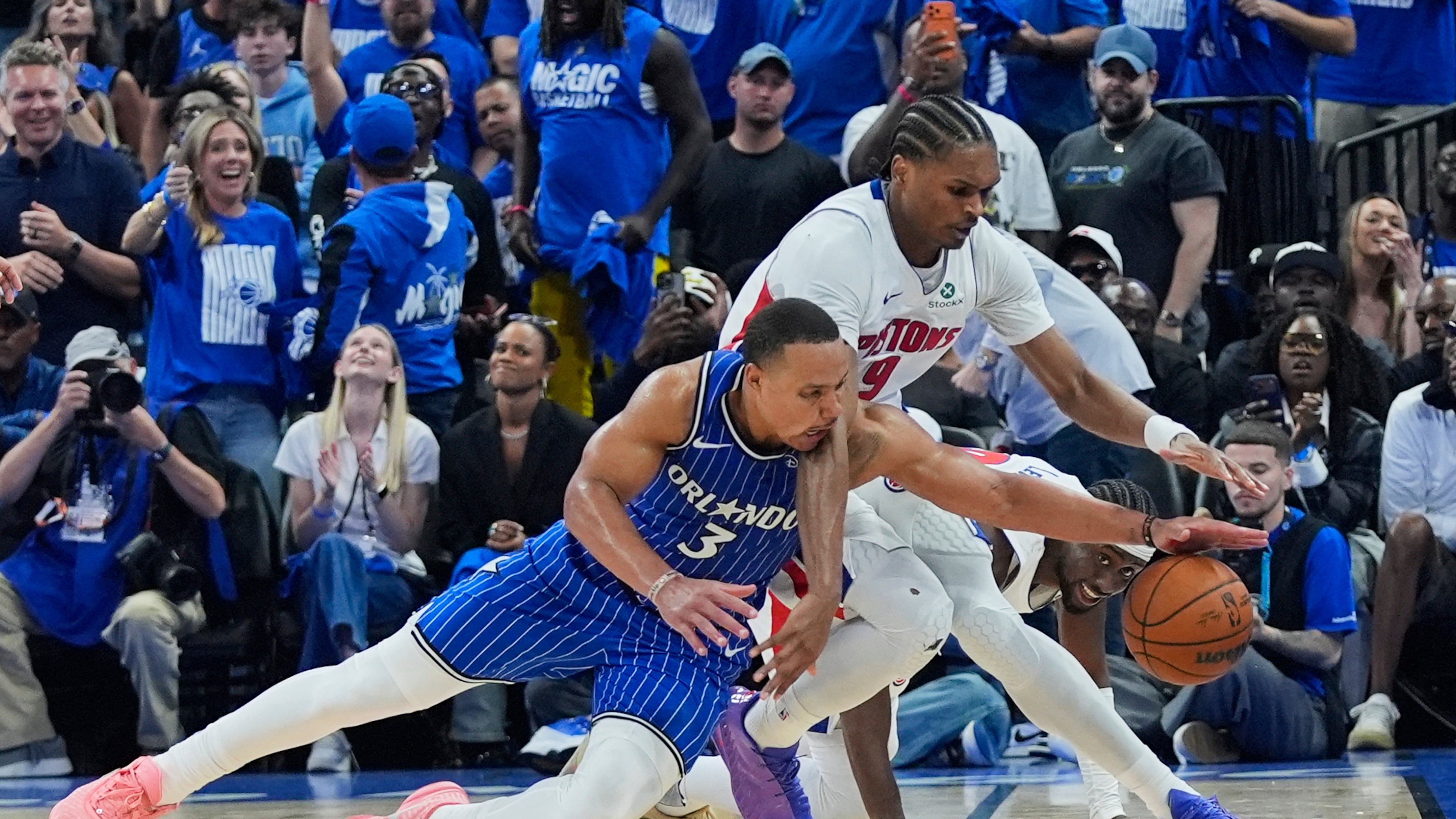 Orlando Magic guard Desmond Bane (3) goes after a loose ball against Detroit Pistons guard Ausar Thompson during the second half in Game 4 of a first-round NBA basketball playoff series, Monday, April 27, 2026, in Orlando, Fla. (AP Photo/John Raoux)