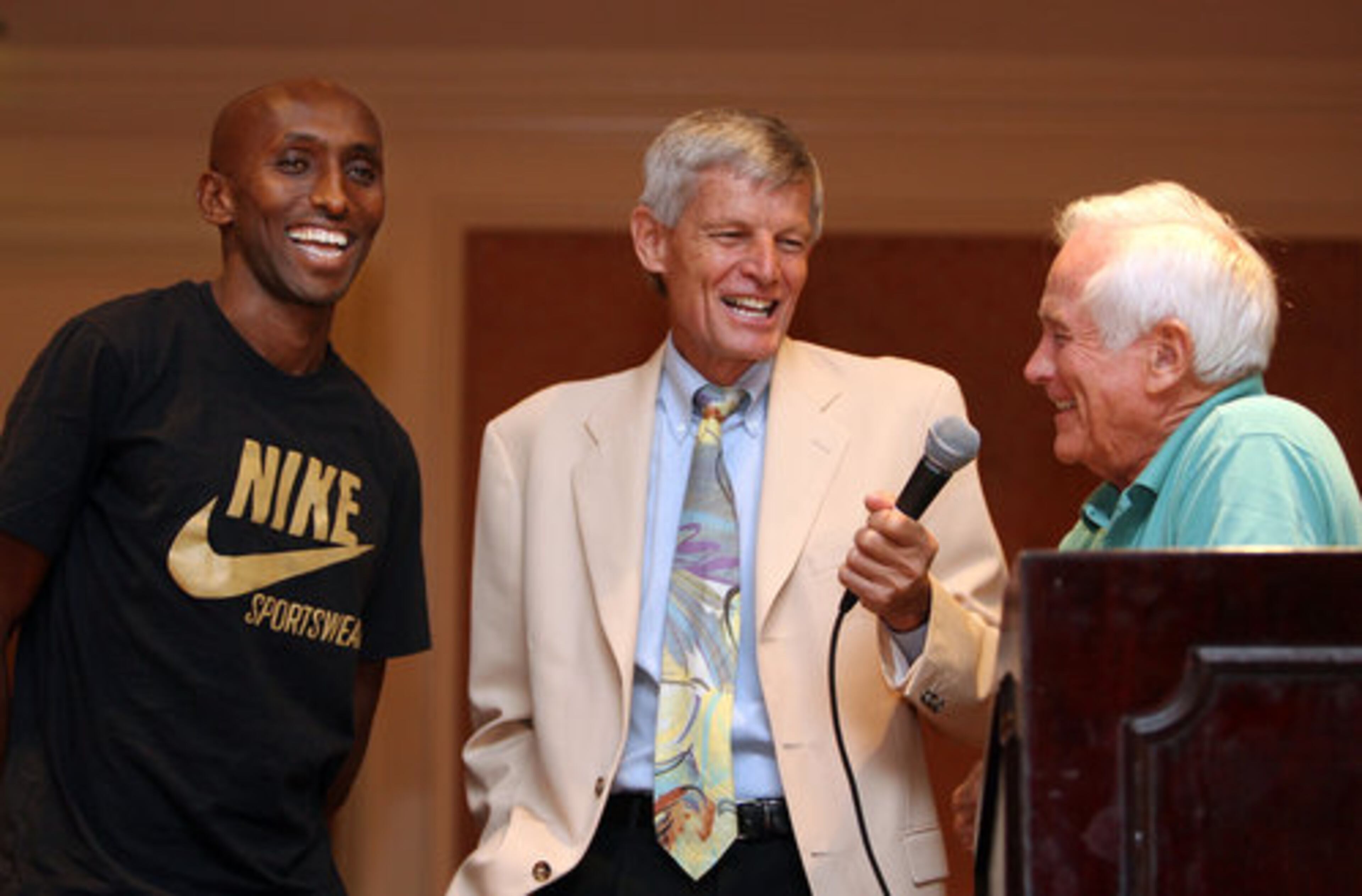 Elite runner Abdi Abdirahman, left, who took 2nd place in the AJC Peachtree Road Race in 2007, laughs at a response to Creigh Kelley's question to Bill Thorn, right, who has run all 39 July 4 races