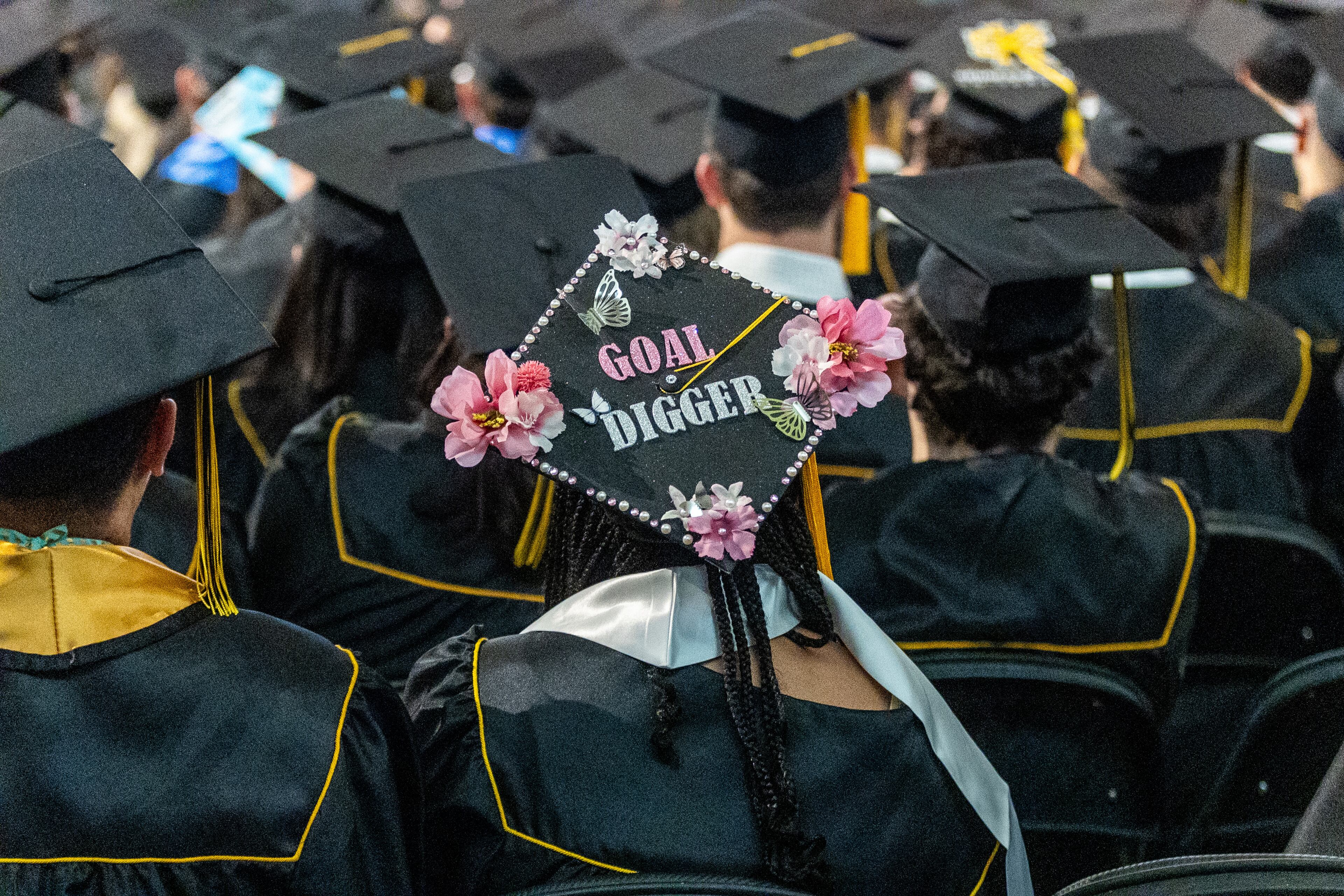 Graduates listen to the commencement speaker during their graduation at Kennesaw State University on Tuesday, May 7, 2014. (Steve Schaefer / AJC)