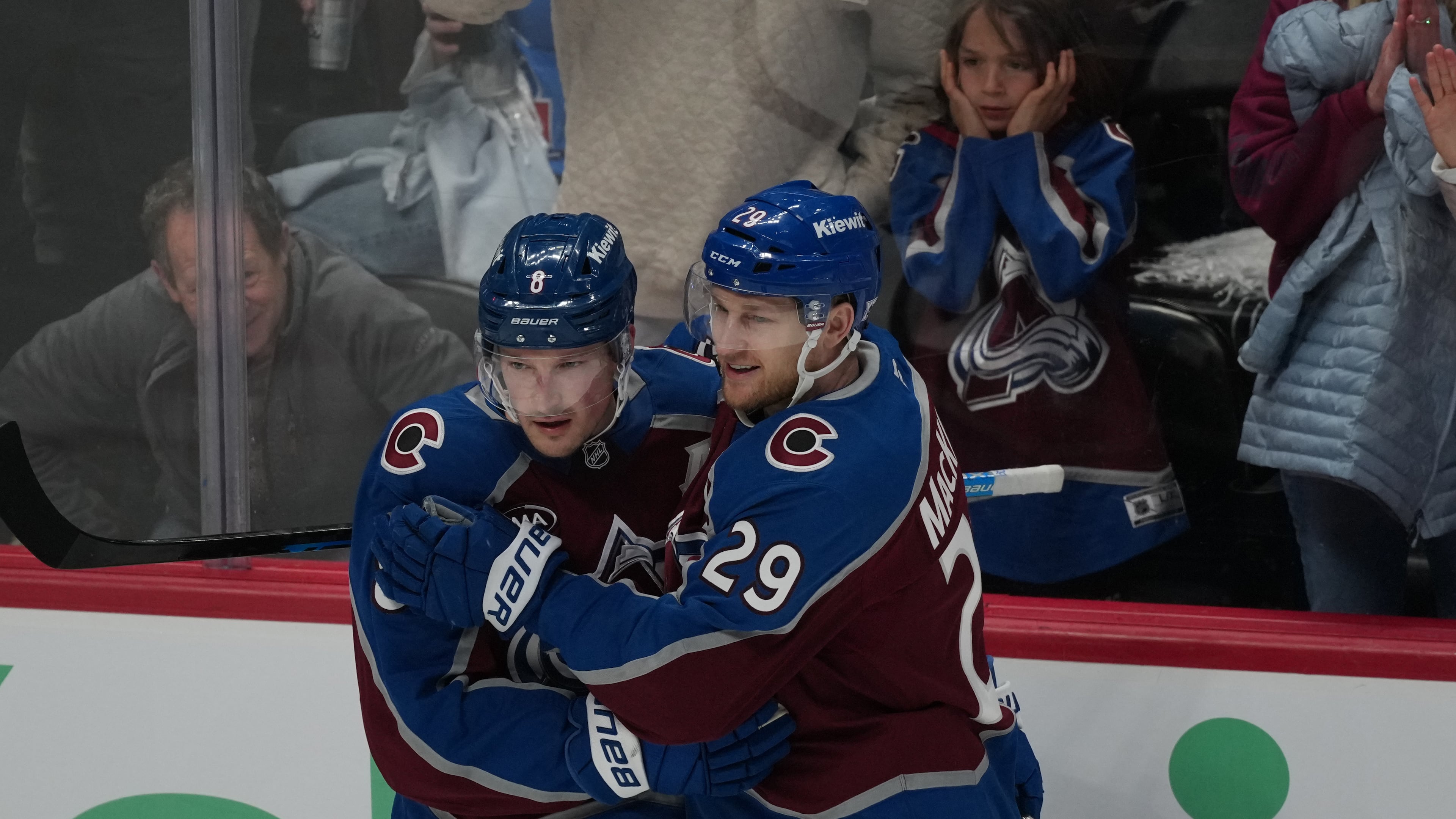 Colorado Avalanche defenseman Cale Makar, left, congratulates center Nathan MacKinnon after he scored a goal against the Minnesota Wild in the third period of Game 1 of an NHL hockey Stanley Cup second-round playoff series Sunday, May 3, 2026, in Denver. (AP Photo/David Zalubowski)