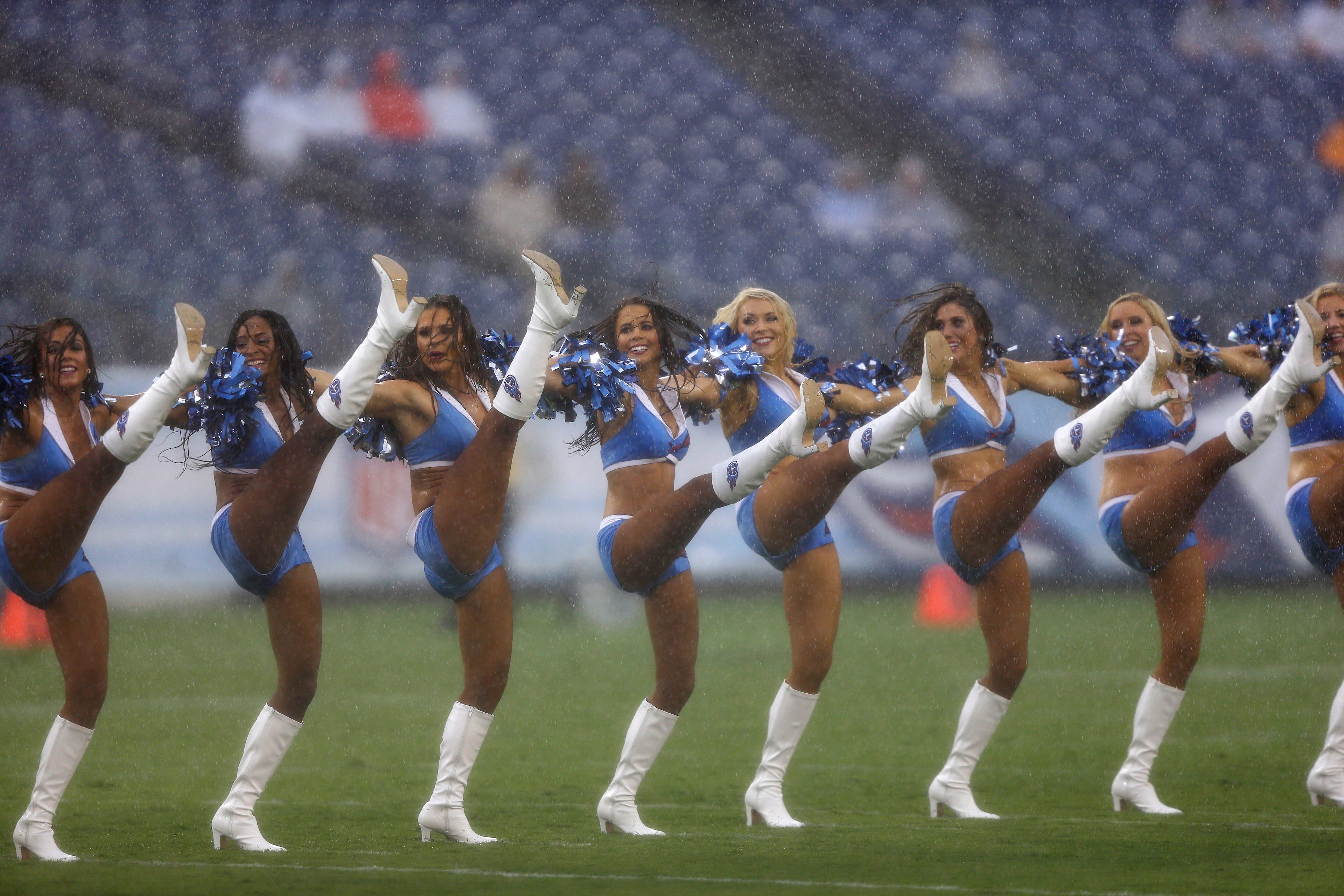 Tennessee Titans cheerleaders perform in the rain before a preseason NFL football game against the Green Bay Packers, Saturday, Aug. 9, 2014, in Nashville, Tenn. (AP Photo/Wade Payne)