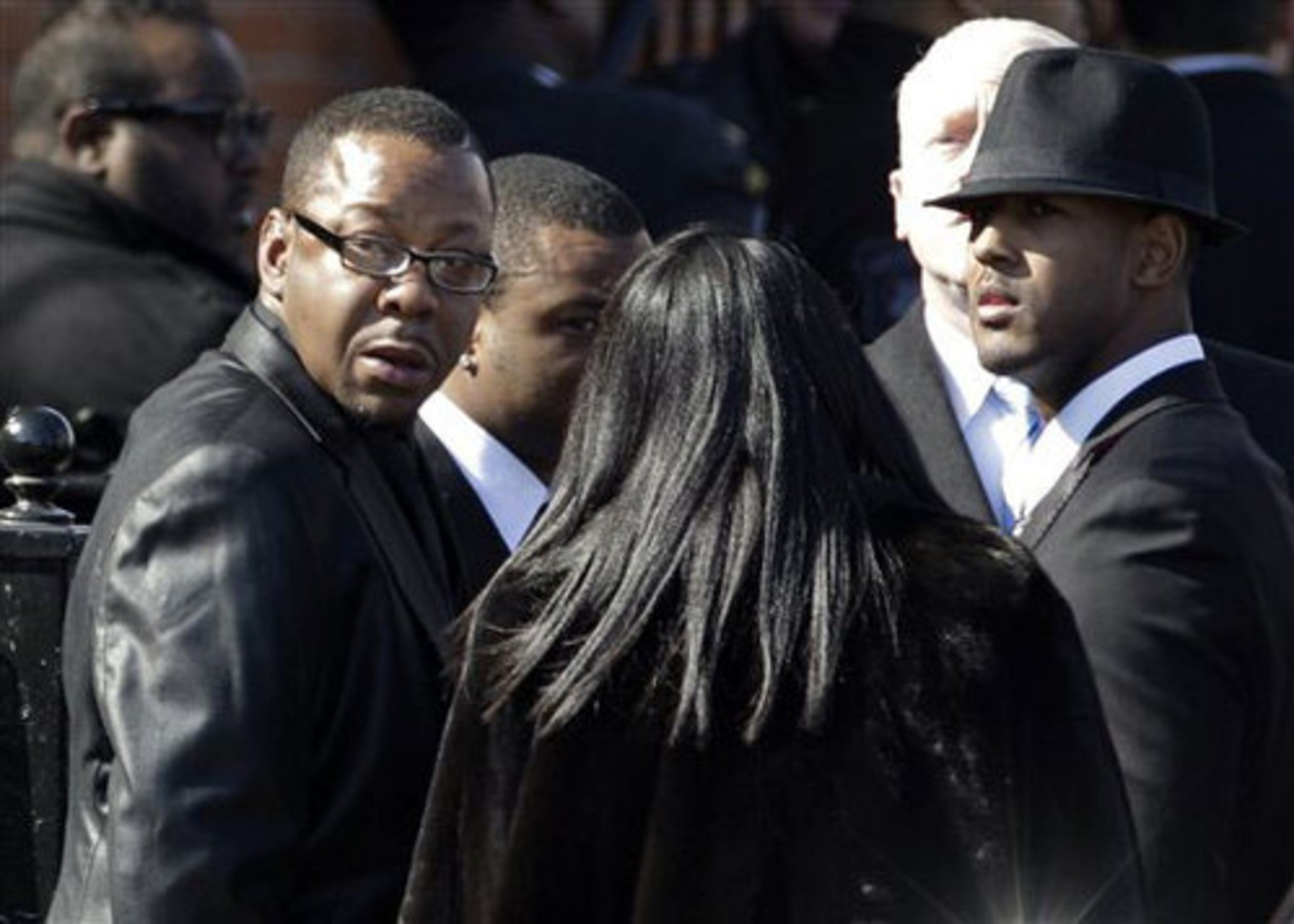 Singer Bobby Brown, left, is seen outside during the funeral of his ex-wife Whitney Houston at New Hope Baptist Church in Newark, N.J., Saturday, Feb. 18, 2012. He made a brief appearance at the funeral before leaving abruptly.
