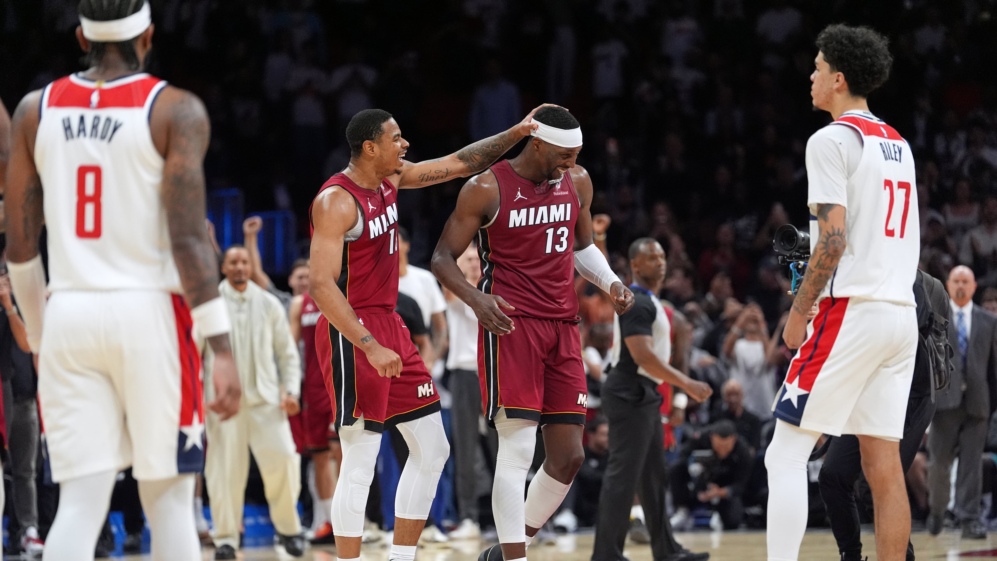 Miami Heat center Bam Adebayo (13) is congratulated by forward Keshad Johnson (16) after reaching 83 points, the second-highest single game total in NBA history, in the second half of an NBA basketball game against the Washington Wizards, Tuesday, March 10, 2026, in Miami. (AP Photo/Rebecca Blackwell)