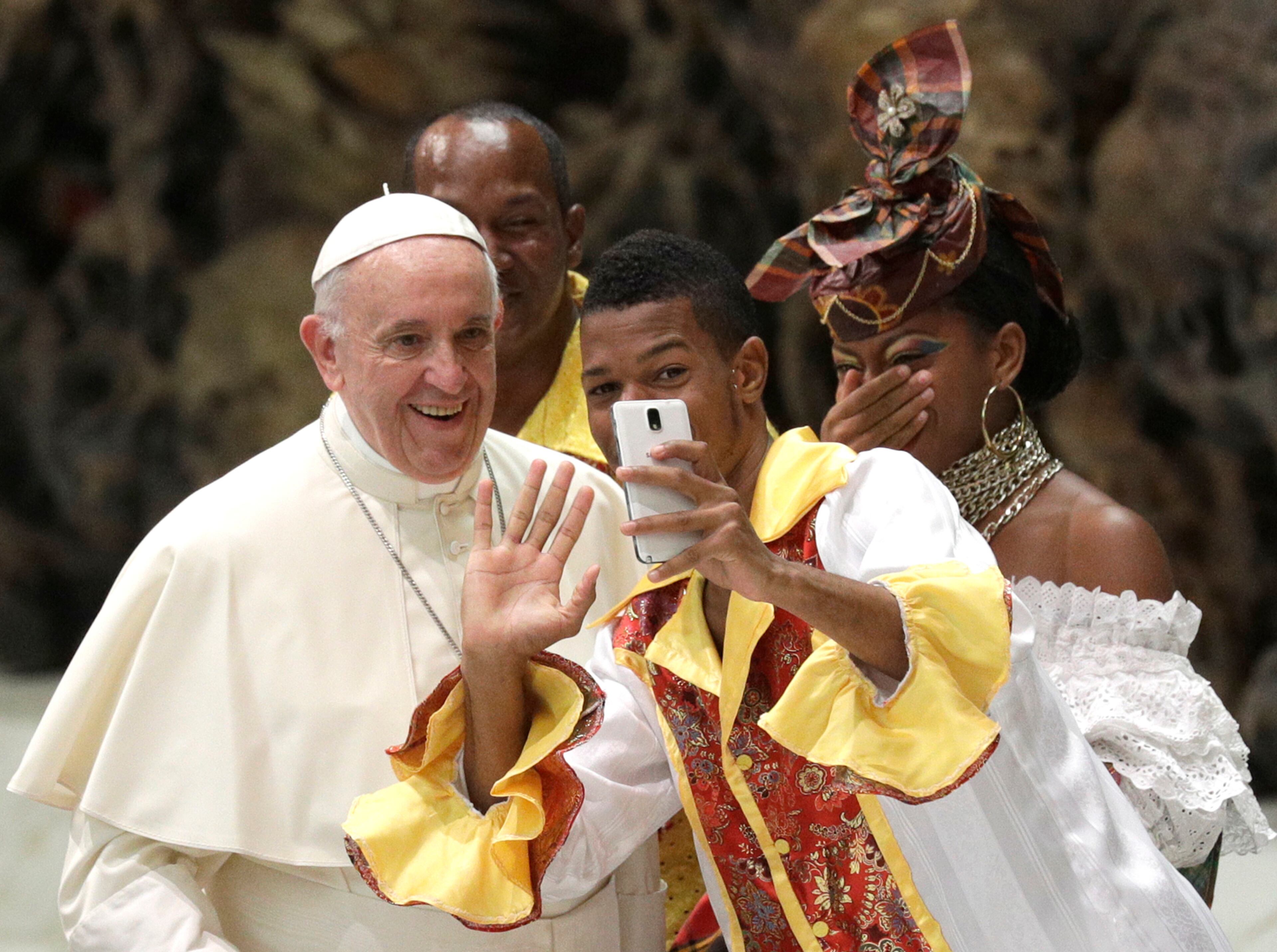 A pilgrim takes a selfie with Pope Francis before the start of the weekly general audience in the Paul VI Hall at the Vatican, Wednesday, Aug. 2, 2017. (AP Photo/Gregorio Borgia)