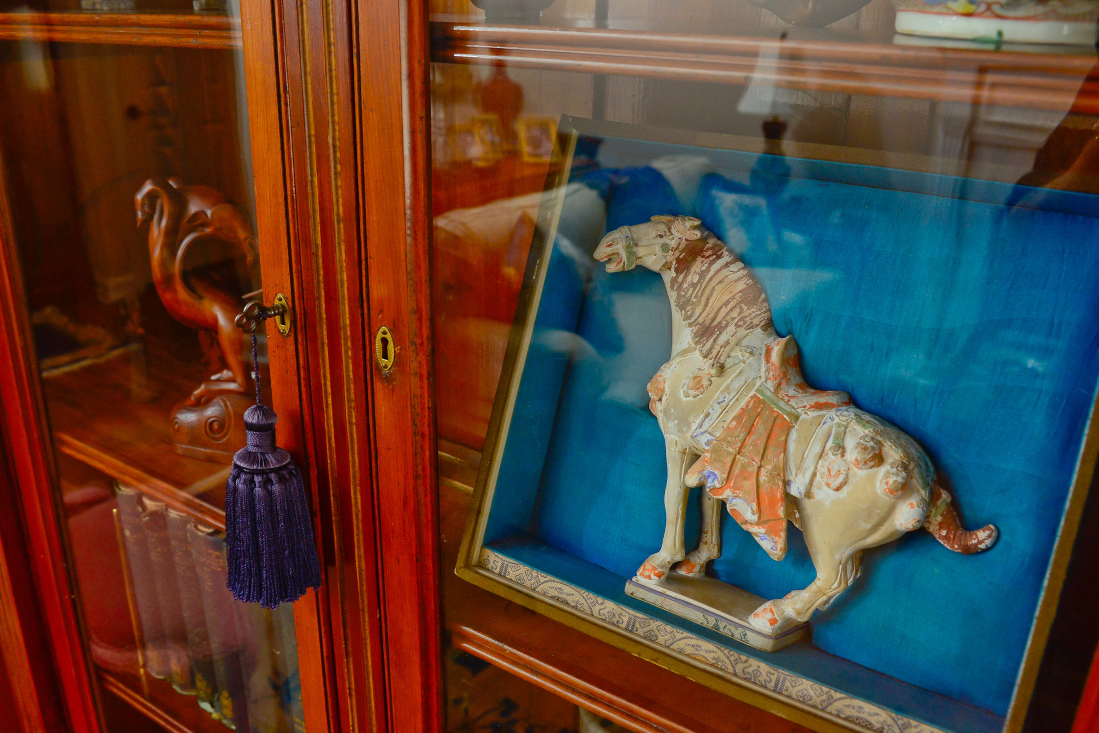Displayed within the antique curio cabinet are souvenirs collected by Chris’ father, Wallace Clark, during his journeys in China. This includes a traditional Chinese horse figurine Wallace received as a gift.