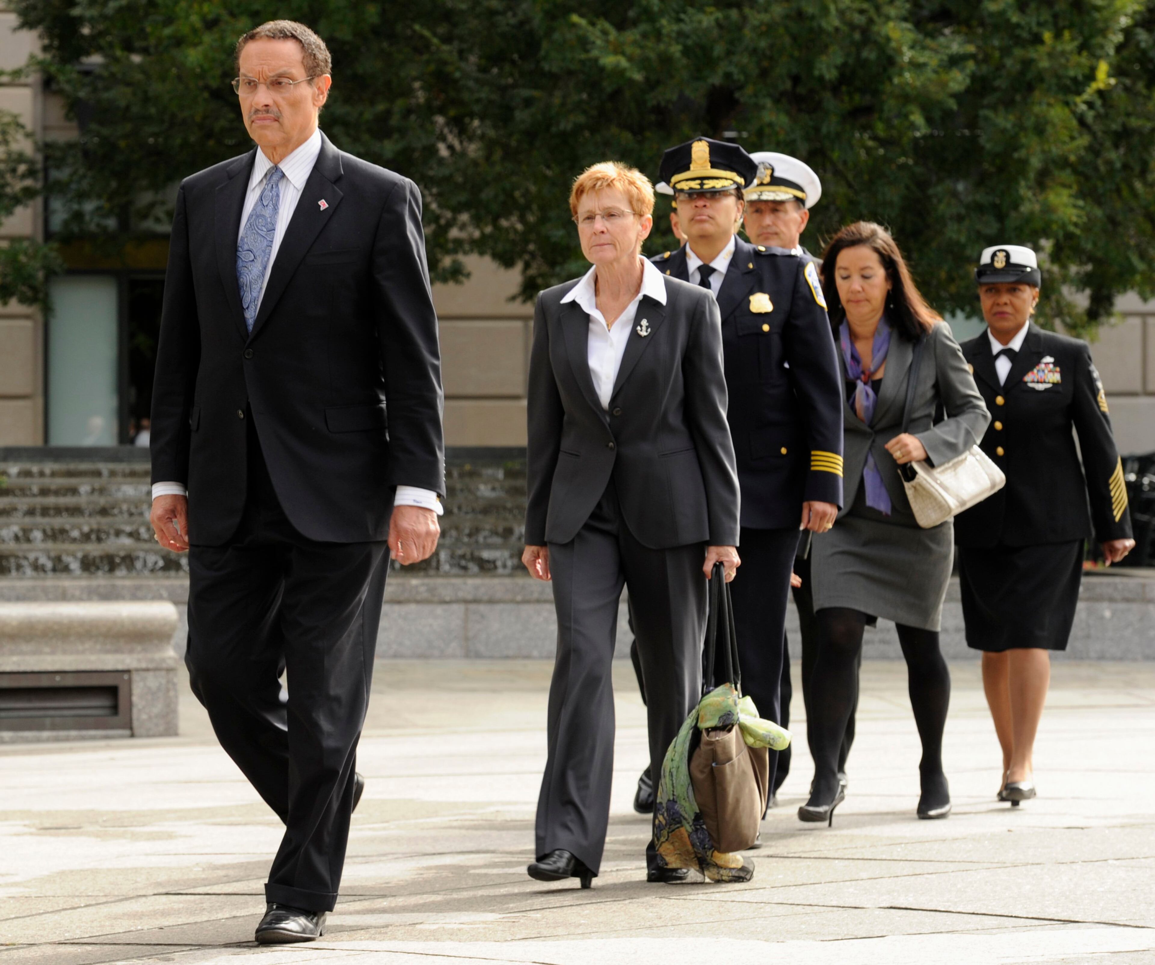 Washington DC Mayor Vincent Gray (L) leads a delegation to join military leaders to a ceremony honoring the victims of the attack at the Navy Yard, at the Navy Memorial in Washington, September 17, 2013. Washington authorities questioned on Tuesday how a U.S. military veteran with a history of violence and mental problems could have gotten clearance to enter a Navy base where he killed 12 people before police shot him dead. The suspect, Aaron Alexis, 34, a Navy contractor from Fort Worth, Texas, entered Washington Navy Yard on Monday morning and opened fire, spreading panic at the base just a mile and a half (2.5 km) from the U.S. Capitol and three miles (4.8 km) from the White House. REUTERS/Mike Theiler