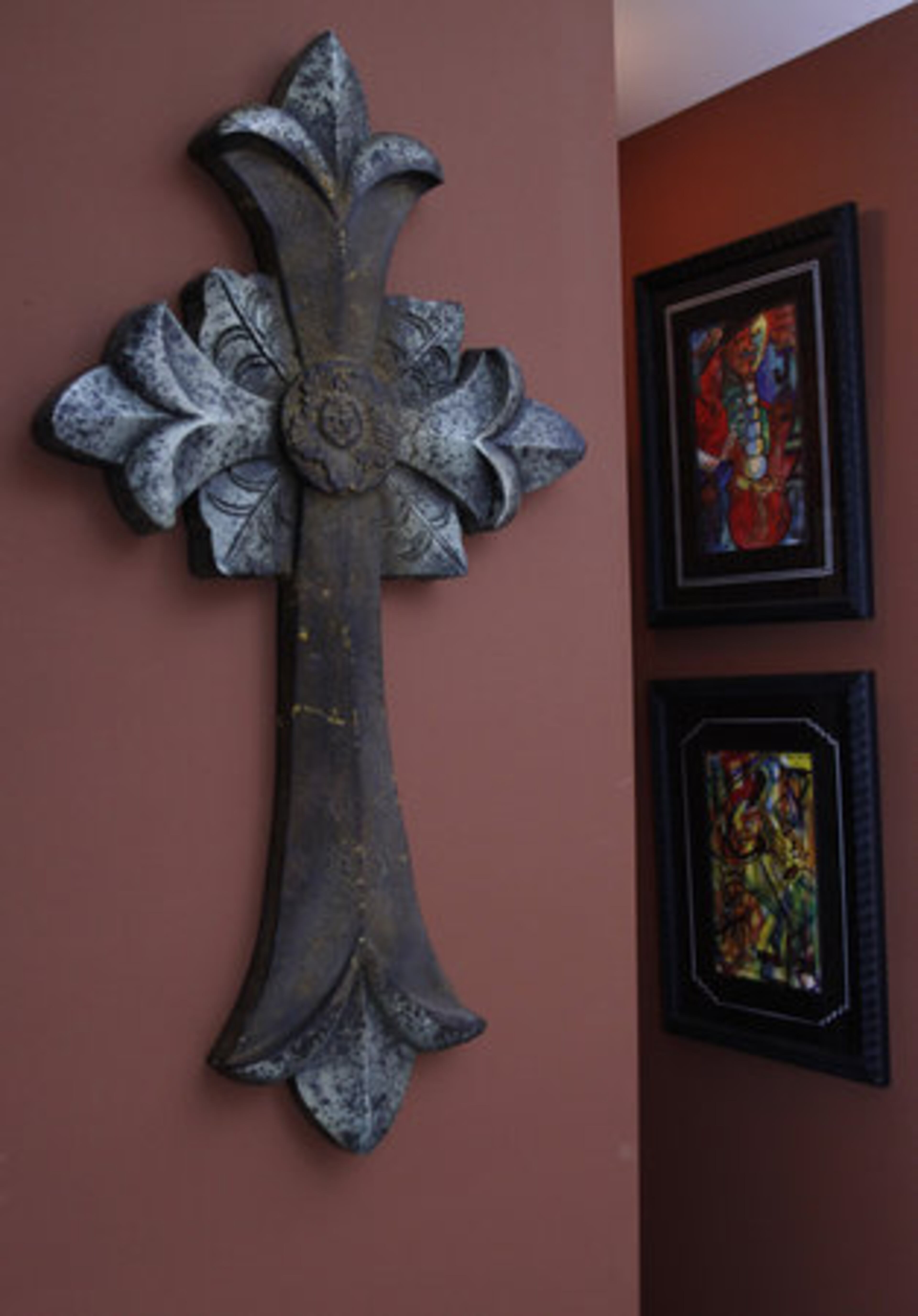 Many of the crosses in DeCuir's home were sourced at Hobby Lobby. "This one I got today at Garden Ridge. They bring a nice Spanish look to the house. And as you see, I believe in having a little anointment over each doorway."