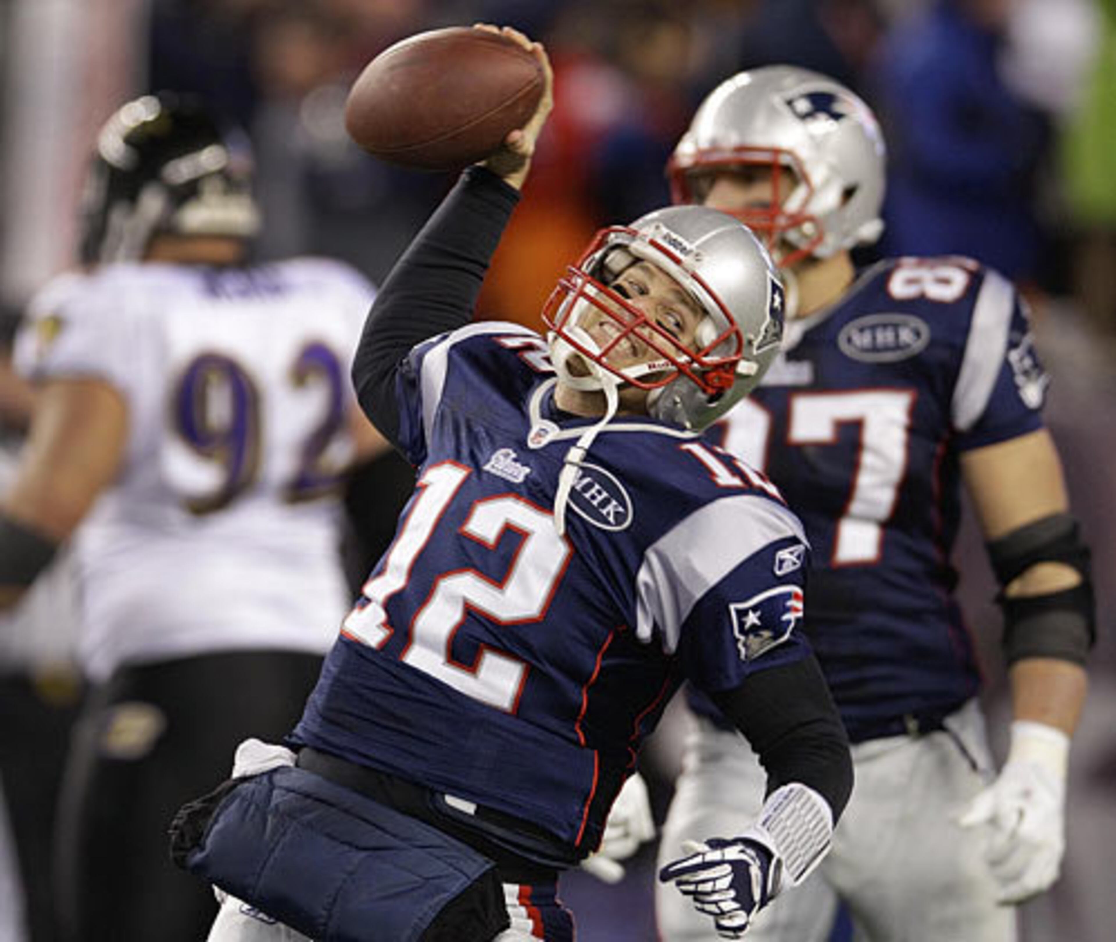 Patriots quarterback Tom Brady (12) celebrates after scoring a one-yard touchdown during the second half against the Ravens to reclaim a lead for New England.