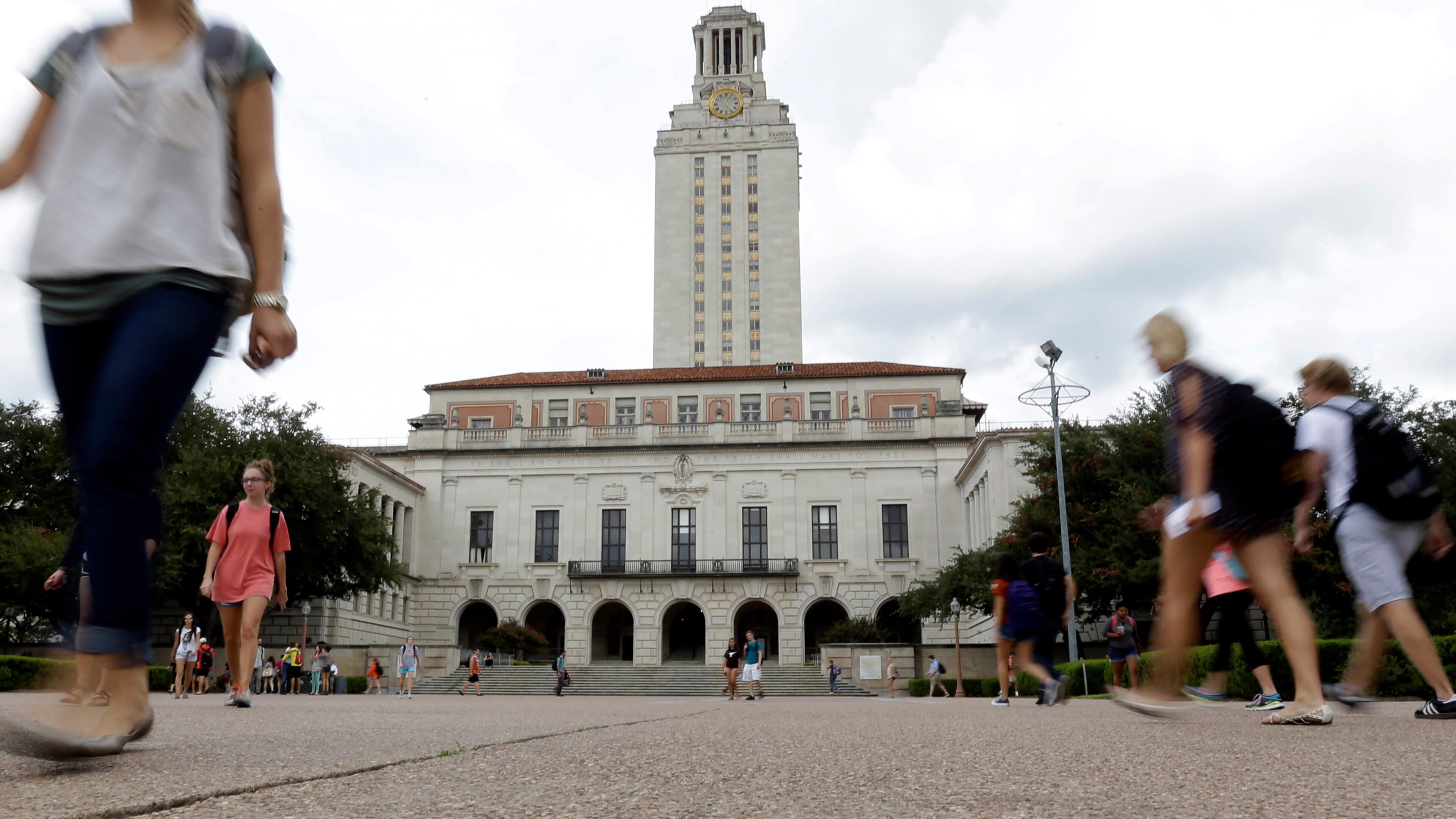 FILE - Students walk through the University of Texas at Austin campus near the school's iconic tower, Sept. 27, 2012, in Austin, Texas. (AP Photo/Eric Gay, File)