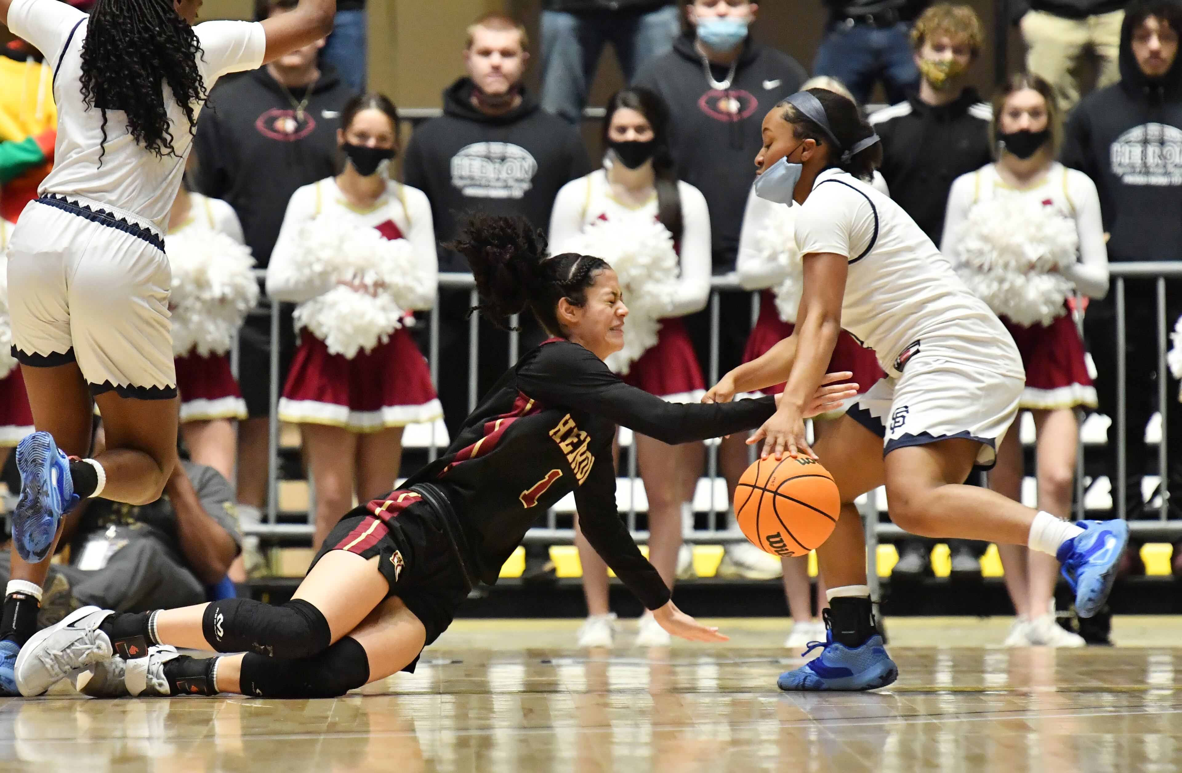 Hebron Christian's Malia Fisher (1) and St. Francis' Morgan Harper (right) fight for a loose ball during the Class A Private girls basketball championship game Wednesday, March 10, 2021, at the Macon Centreplex in Macon. Hebron Christian won 51-46 in overtime. (Hyosub Shin / Hyosub.Shin@ajc.com)