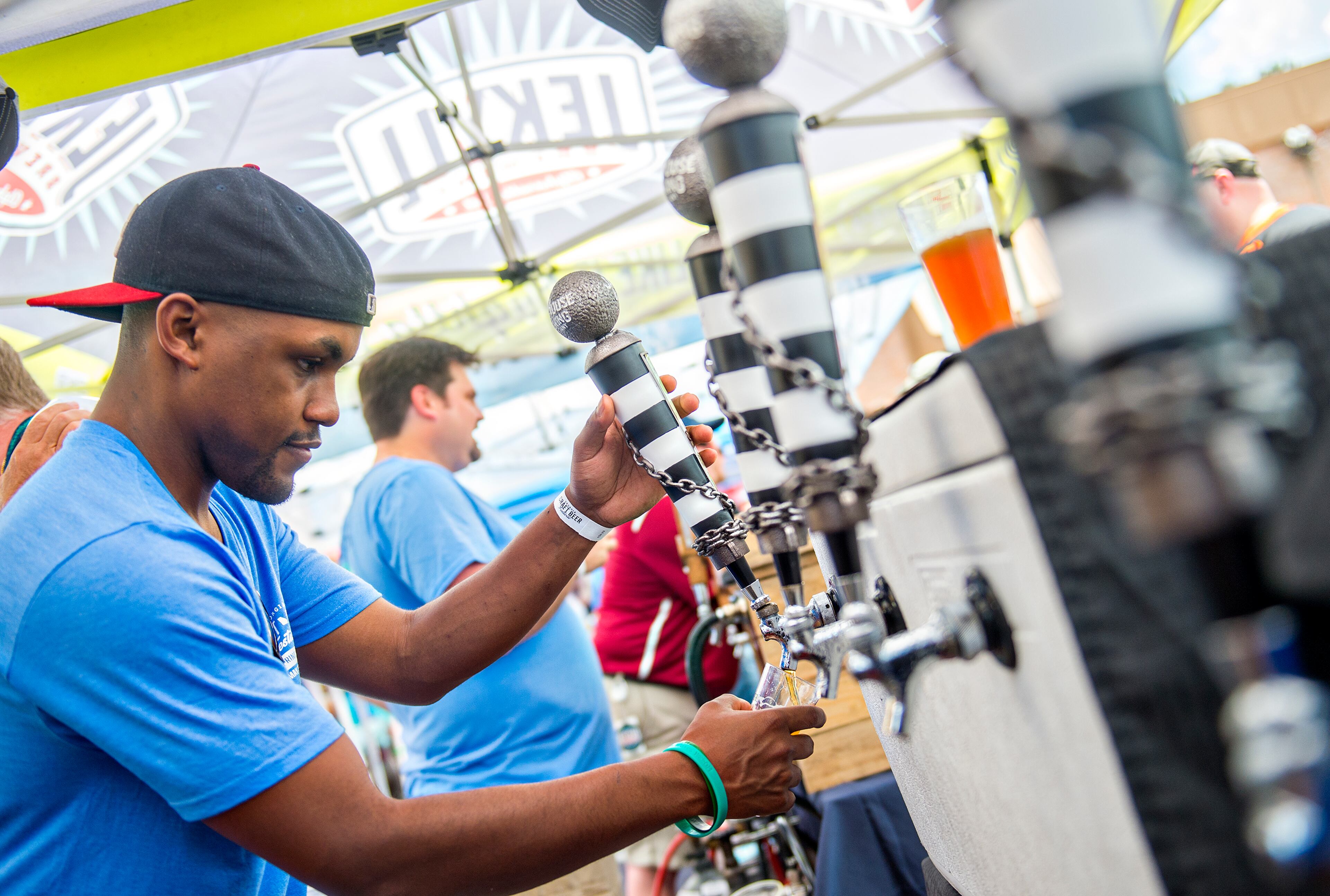 May 30, 2015 Atlanta - CJ Cypress pours a fresh beer from Jailhouse Brewing during the Georgia Craft Beer Festival outside of Red Brick Brewing in Atlanta on Saturday, May 30, 2015. Hundreds of people came out to taste beer from 30 local Georgia breweries. JONATHAN PHILLIPS / SPECIAL