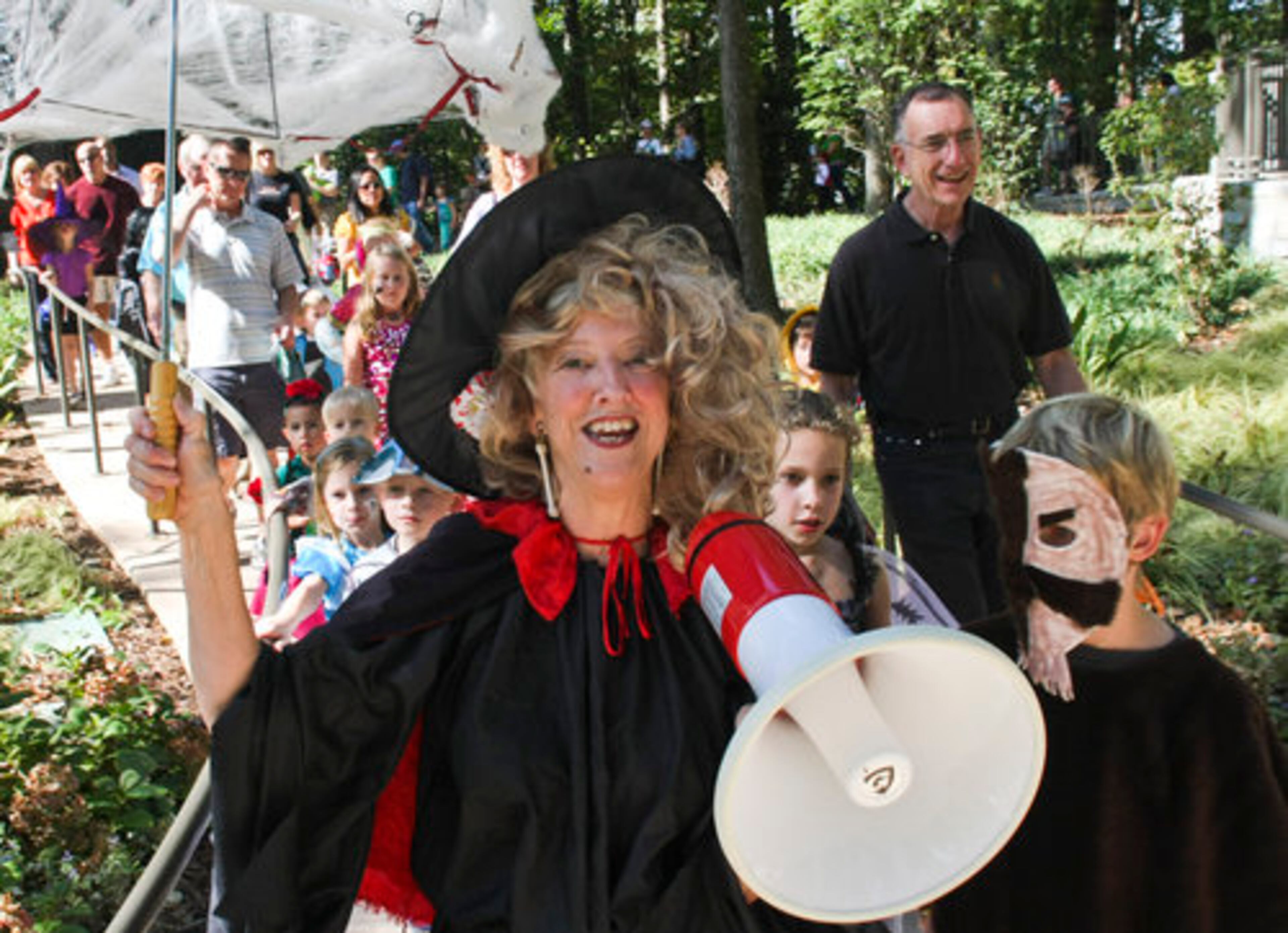 Betty Ann Wiley of Journey to Literacy Junior League of Atlanta leads the children and families participating in the kiddie costume parade during Atlanta Botanical Garden's annual Goblins in the Garden, Sunday, October 24, 2010.