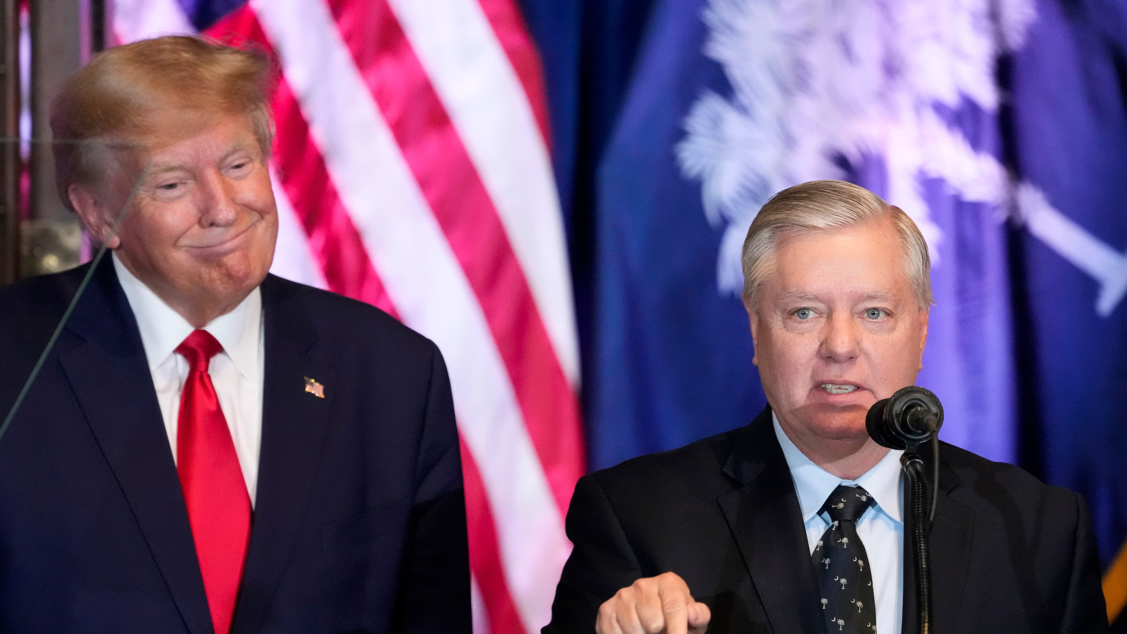FILE - Former President Donald Trump listens as Sen. Lindsey Graham, R-S.C., speaks at a campaign event at the South Carolina Statehouse, Jan. 28, 2023, in Columbia, S.C. (AP Photo/Alex Brandon, File)