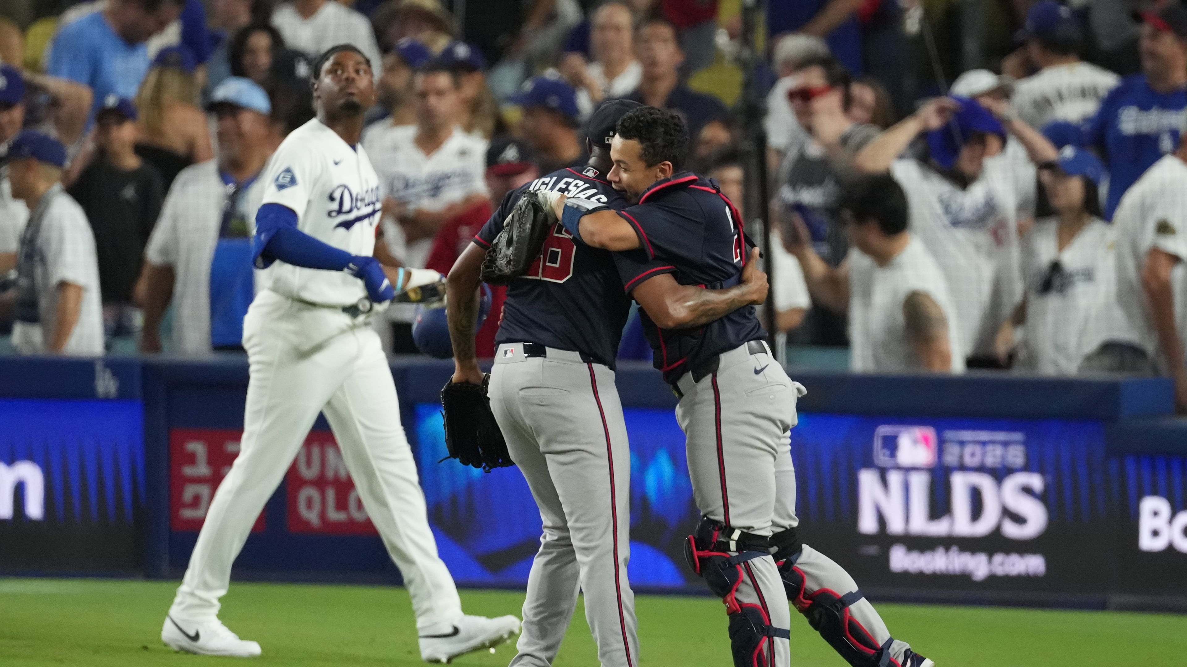 Atlanta Braves pitcher Raisel Iglesias (center) celebrates with catcher Drake Baldwin as Los Angeles Dodgers' Josue De Paula looks on (left) after the Braves defeated the Dodgers 3-2 in Game 2 of the National League Division Series Sunday, Oct. 4, 2026, in Los Angeles.(Jae C. Hong/AP)
