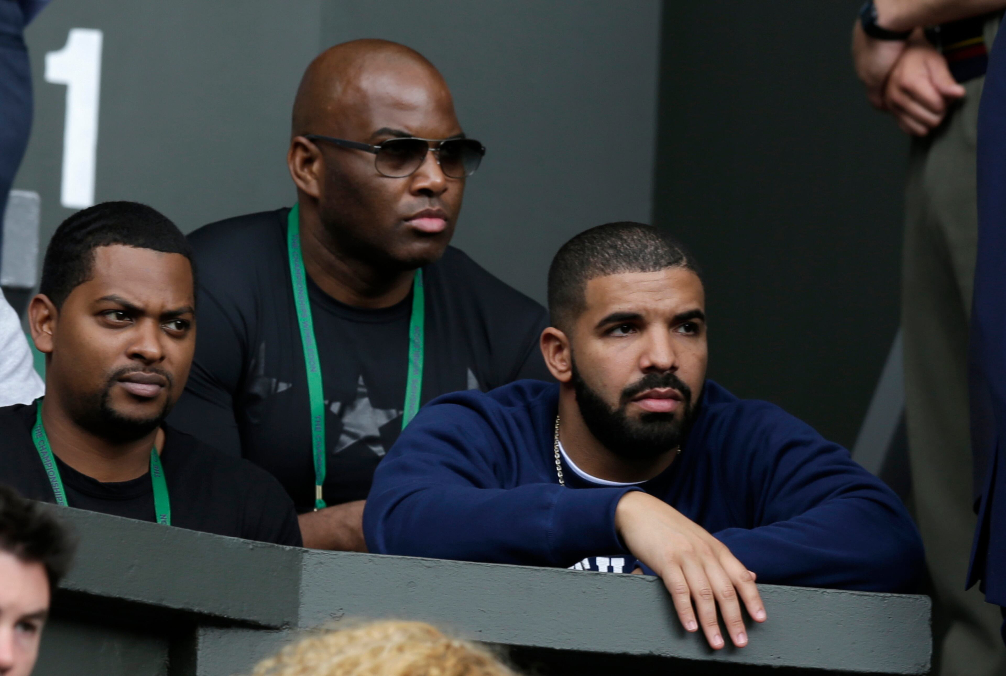 Canadian performer Drake, right, sits on Centre Court to watch the singles match between Serena Williams of the United States and Victoria Azarenka of Belarus, at the All England Lawn Tennis Championships in Wimbledon, London, Tuesday July 7, 2015. (AP Photo/Pavel Golovkin)