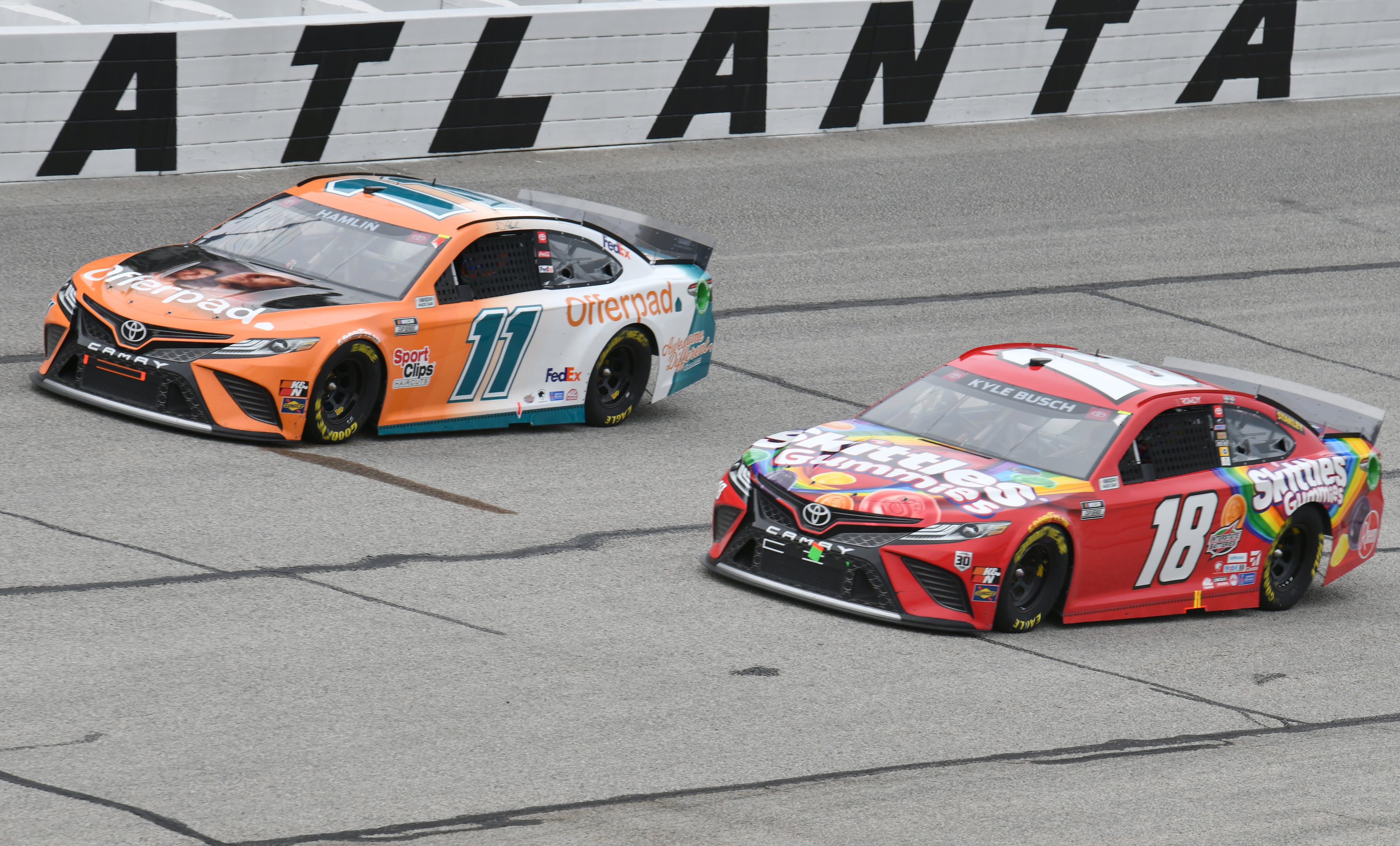 Kyle Busch (18) and Denny Hamlin (11) lead during the Quaker State 400 presented by Walmart Sunday, July 11, 2021, at Atlanta Motor Speedway in Hampton. (Hyosub Shin / Hyosub.Shin@ajc.com)