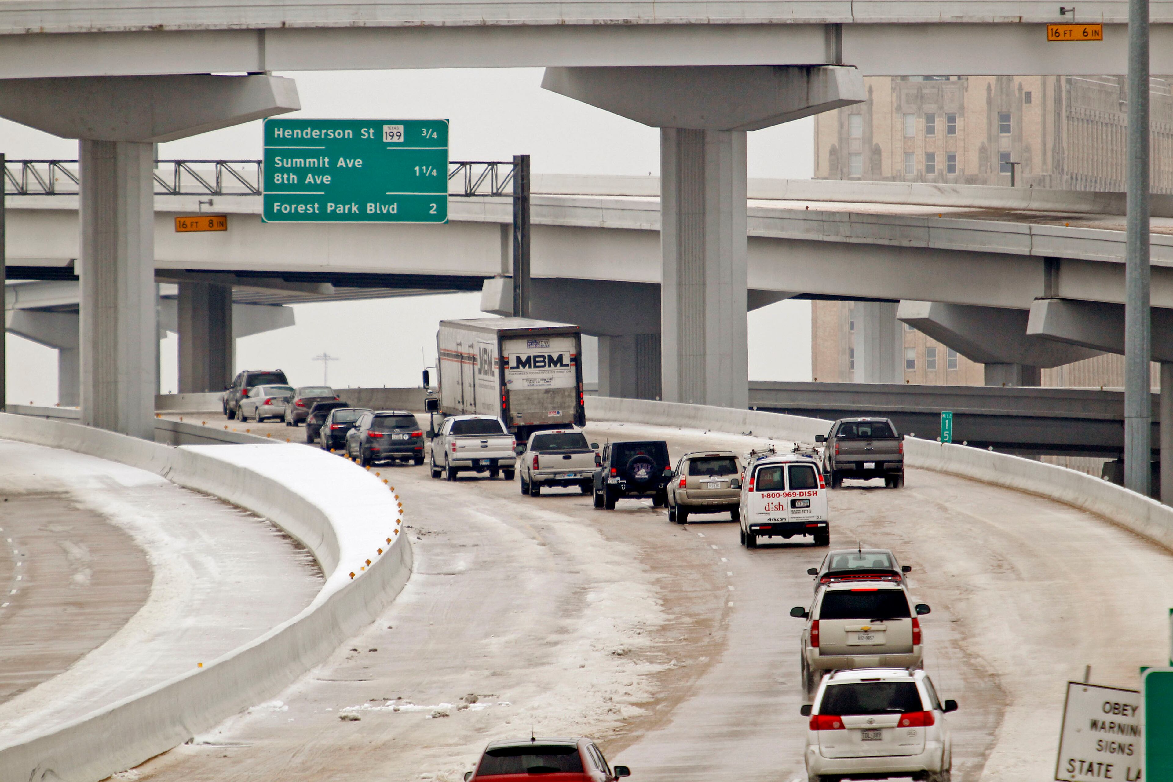 The I-35 W / I-30 mixmaster was slow but passable Sunday, Dec. 8, 2013 if drivers were careful. Cold and ice remained in Fort Worth, Texas, with roads especially treacherous in the the morning hours before temperatures rose.