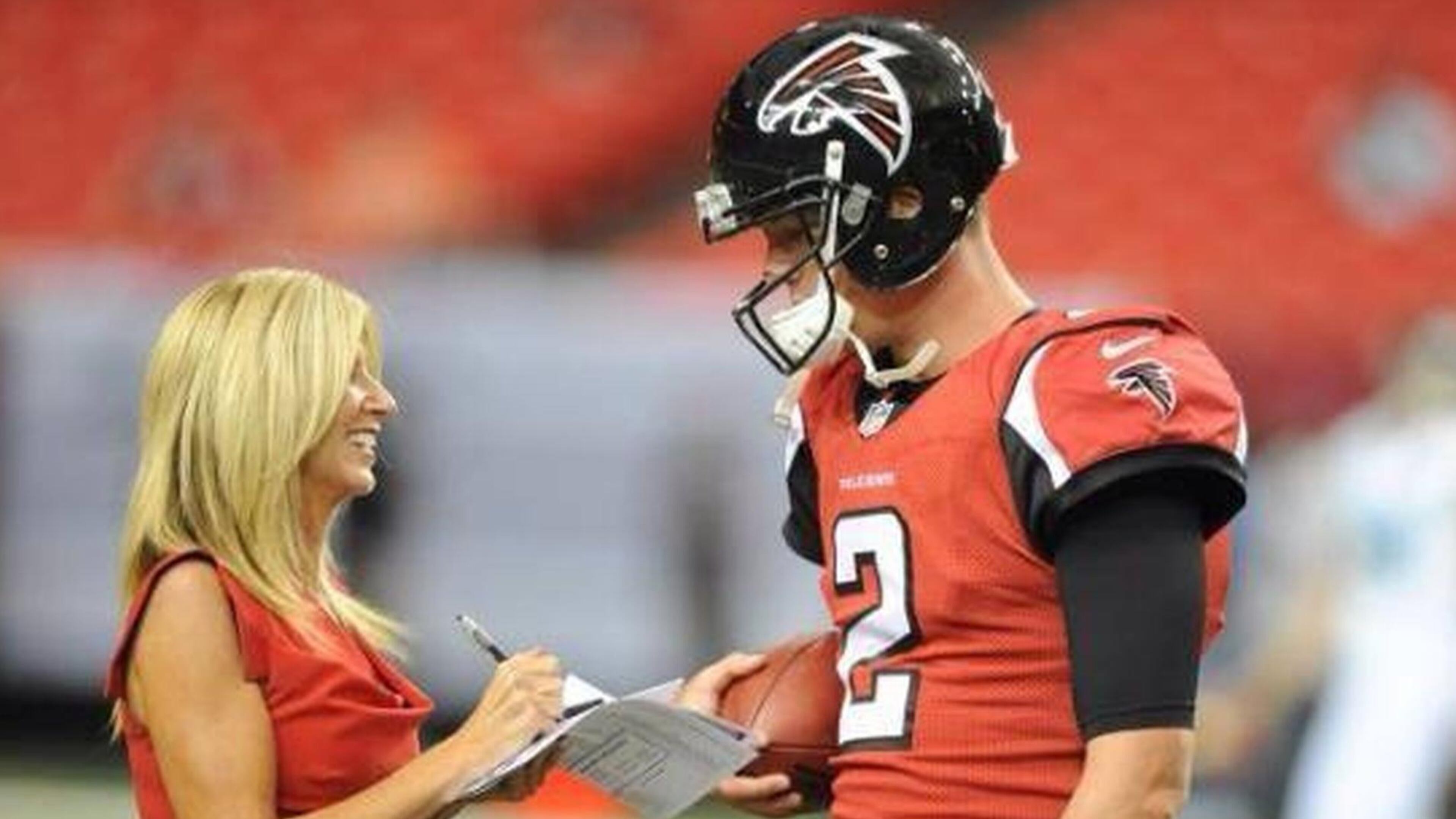 Veteran NFL sideline reporter Laura Okmin with Falcons quarterback Matt Ryan. (Special to the AJC)