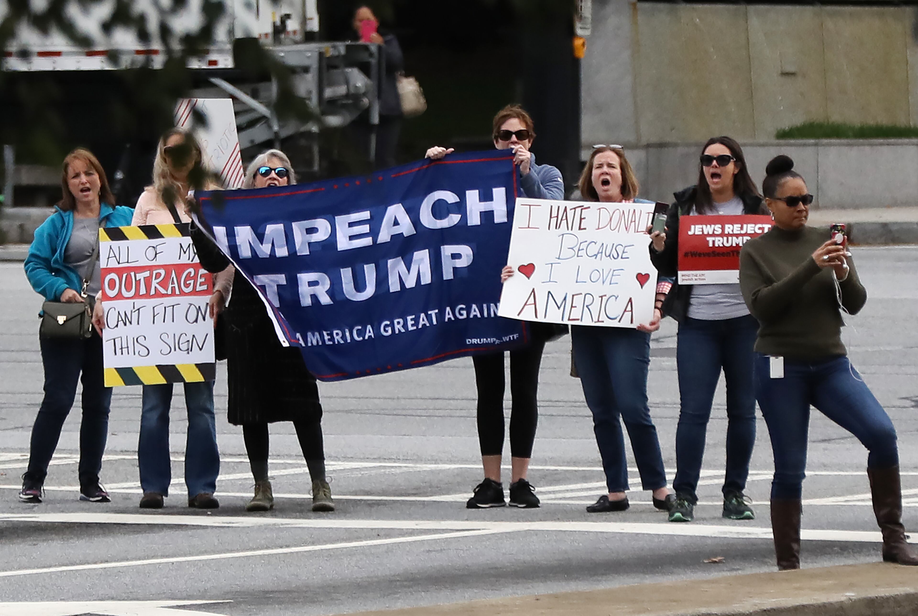 November 8, 2019 Atlanta: Protesters stand on the sidewalk outside the Ritz-Carlton in Buckhead as President Donald Trump arrives for a fundraiser on Friday, November 8, 2019, in Atlanta. Curtis Compton/ccompton@ajc.com