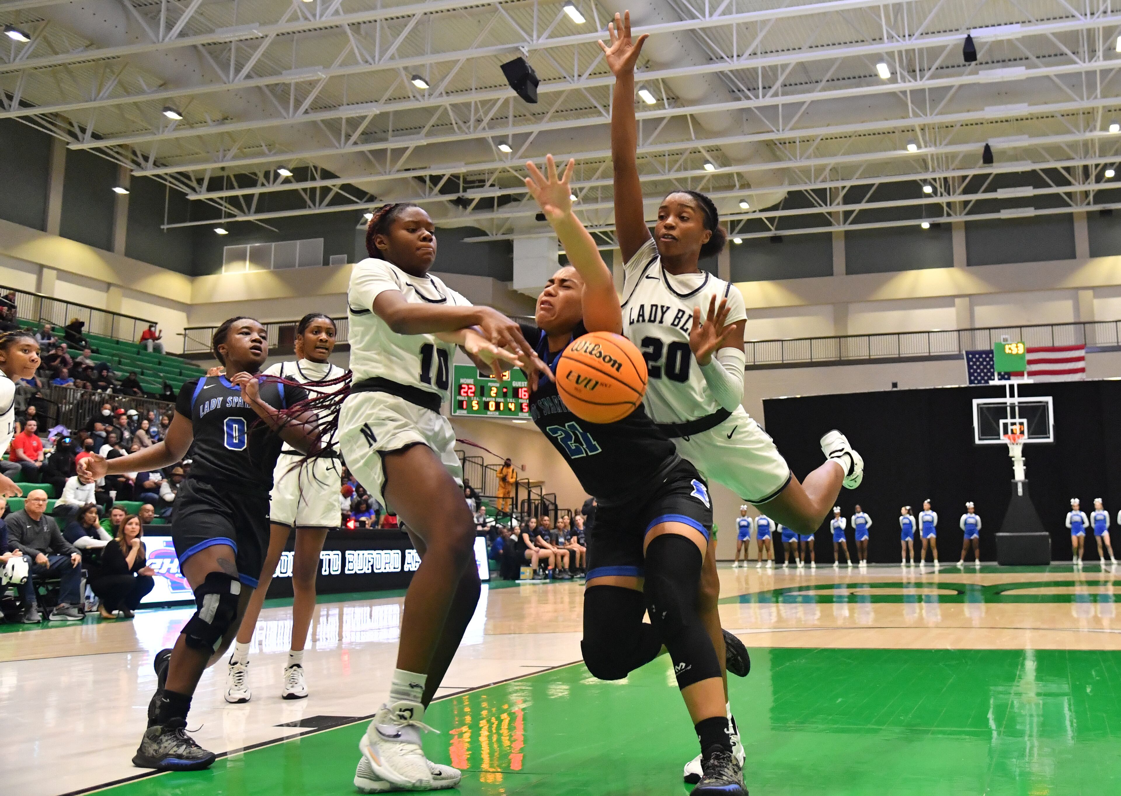 Campbell's Laila Battle (21) loses the ball as she drives between Norcross' Kayla Lindsey (10) and Norcross' Zaria Hurston (20) in the first half of 2022 GHSA Basketball Playoffs at Buford Arena on Friday, March 4, 2022. (Hyosub Shin / Hyosub.Shin@ajc.com)