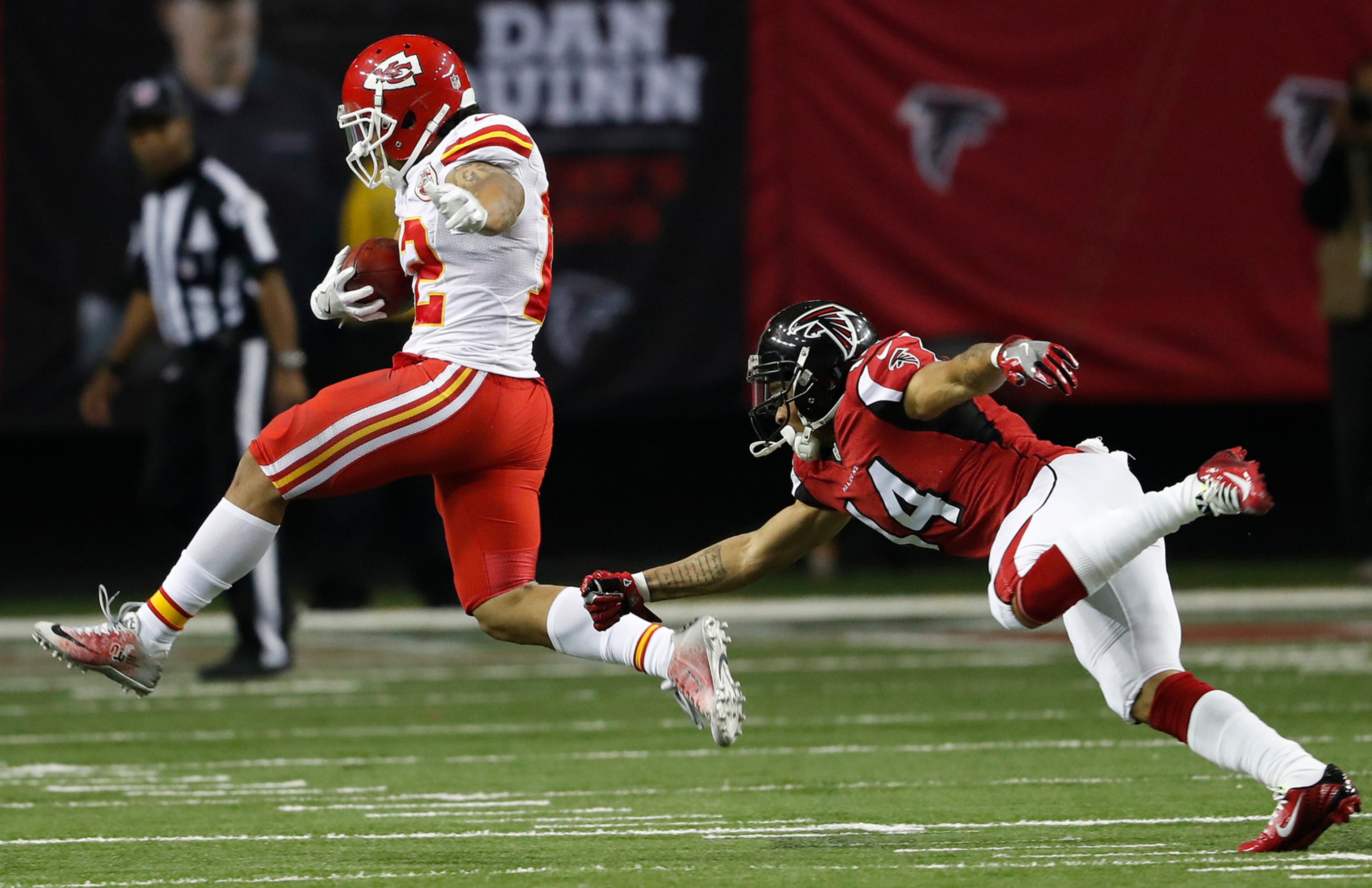 Kansas City Chiefs wide receiver Albert Wilson (12) runs after intercepting a Atlanta Falcons quarterback Matt Ryan pass as Atlanta Falcons wide receiver Eric Weems (14) defends during the second half of an NFL football game, Sunday, Dec. 4, 2016, in Atlanta. (AP Photo/John Bazemore)