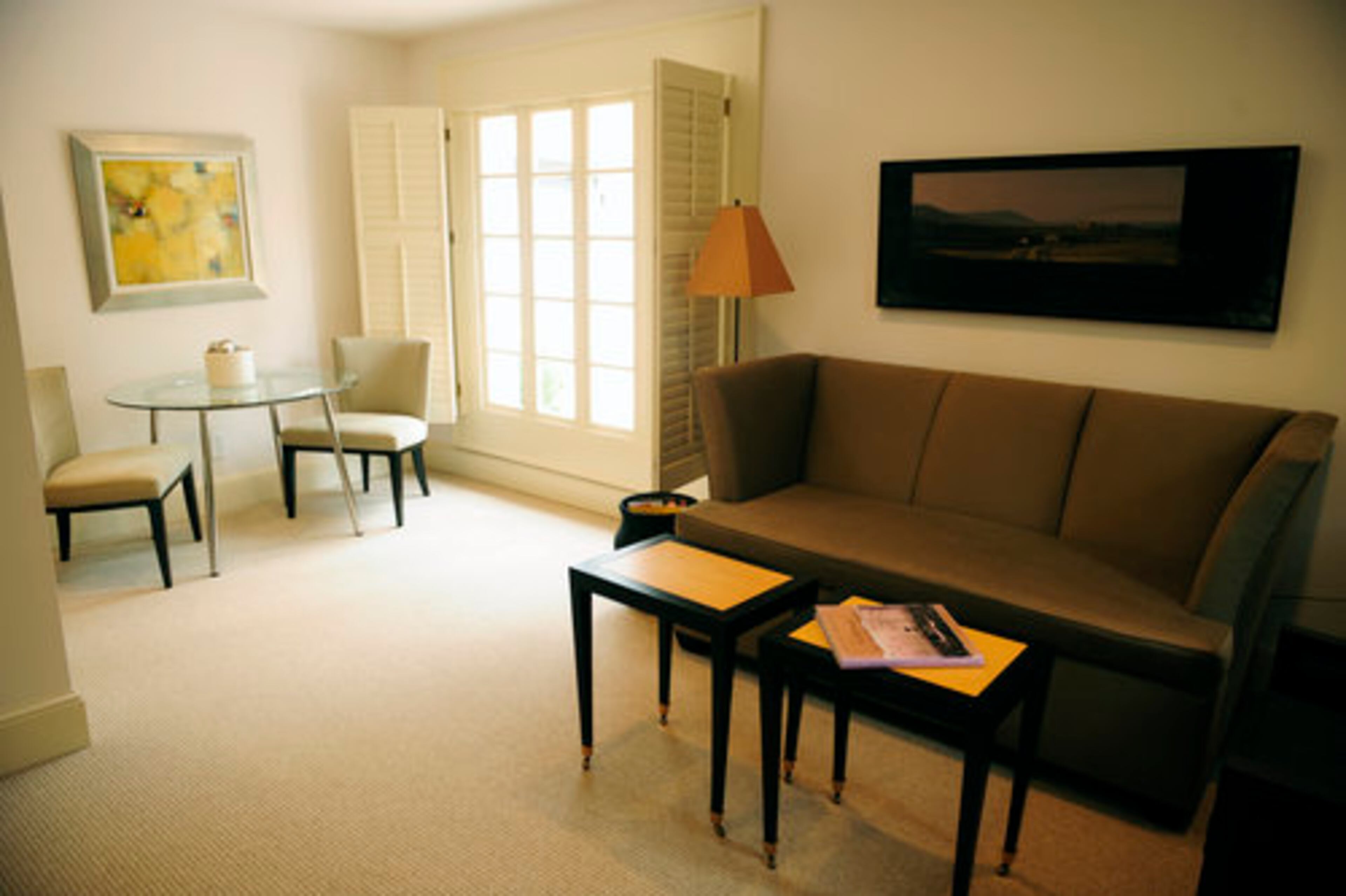 The Devines designed the guest house with their own eye -- and things! For example, the sofa and painting came from Foy's old office. "We just kind of made it work," he says. This ground floor apartment also houses their exercise room.