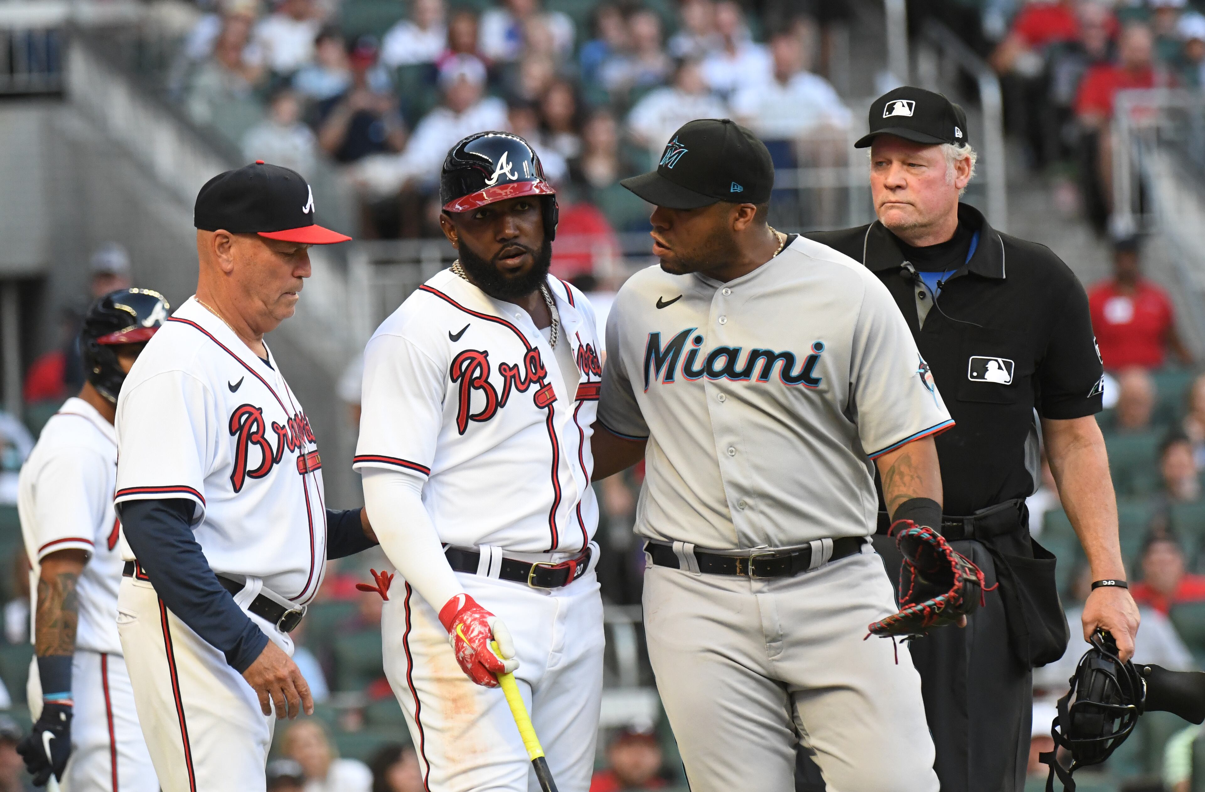 April 23, 2022 Atlanta - Atlanta Braves' left fielder Marcell Ozuna (20) and Miami Marlins' first base coach Keith Johnson (99) talk after Ozuna was hit by a pitch in the first inning at Truist Park on Saturday, April 23, 2022. (Hyosub Shin / Hyosub.Shin@ajc.com)