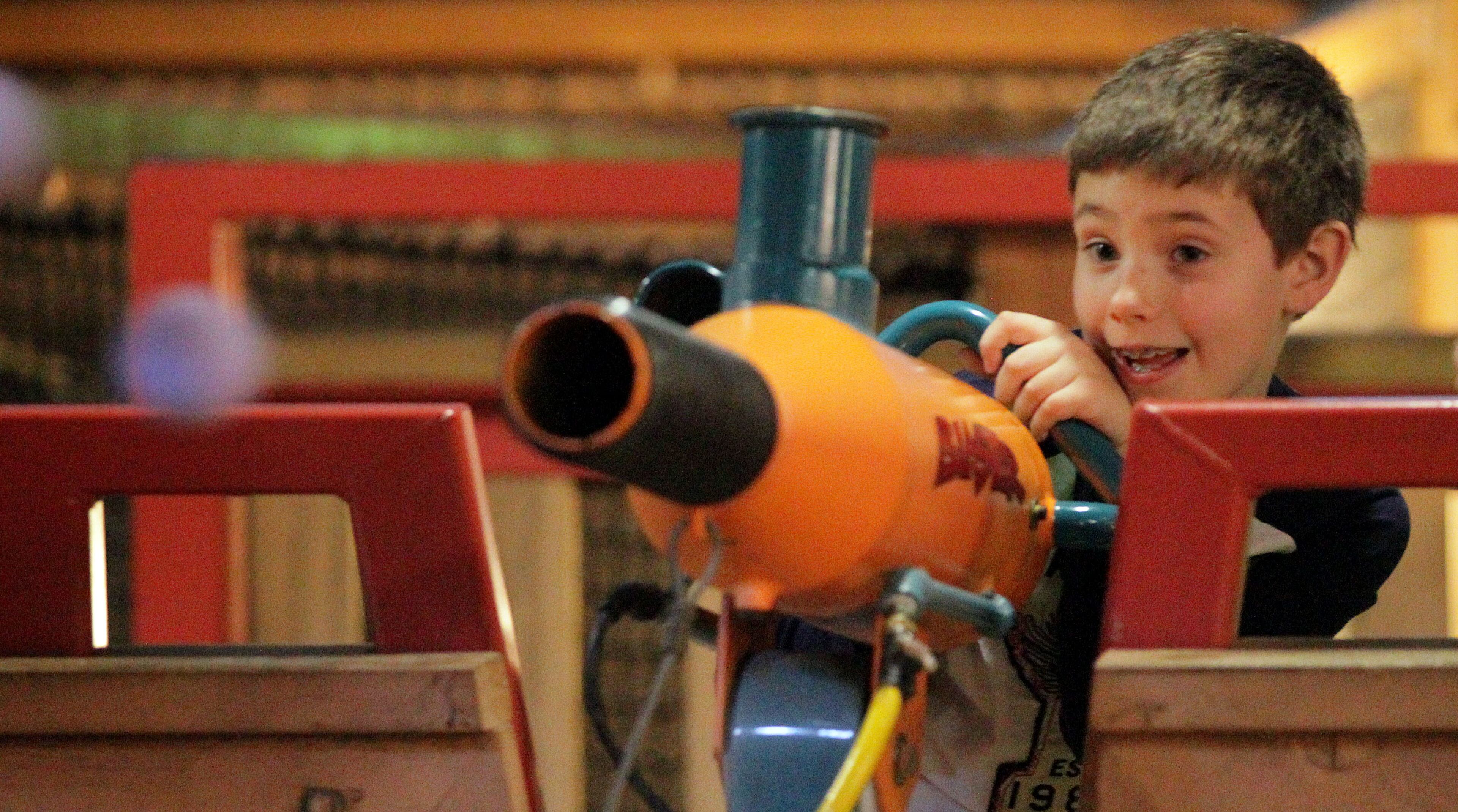 Cooper Sunderland shoots rubber balls out of a "blaster" at Stone Mountain Christmas at Crossroads, located at the base of Stone Mountain on Saturday, Nov. 10, 2012.