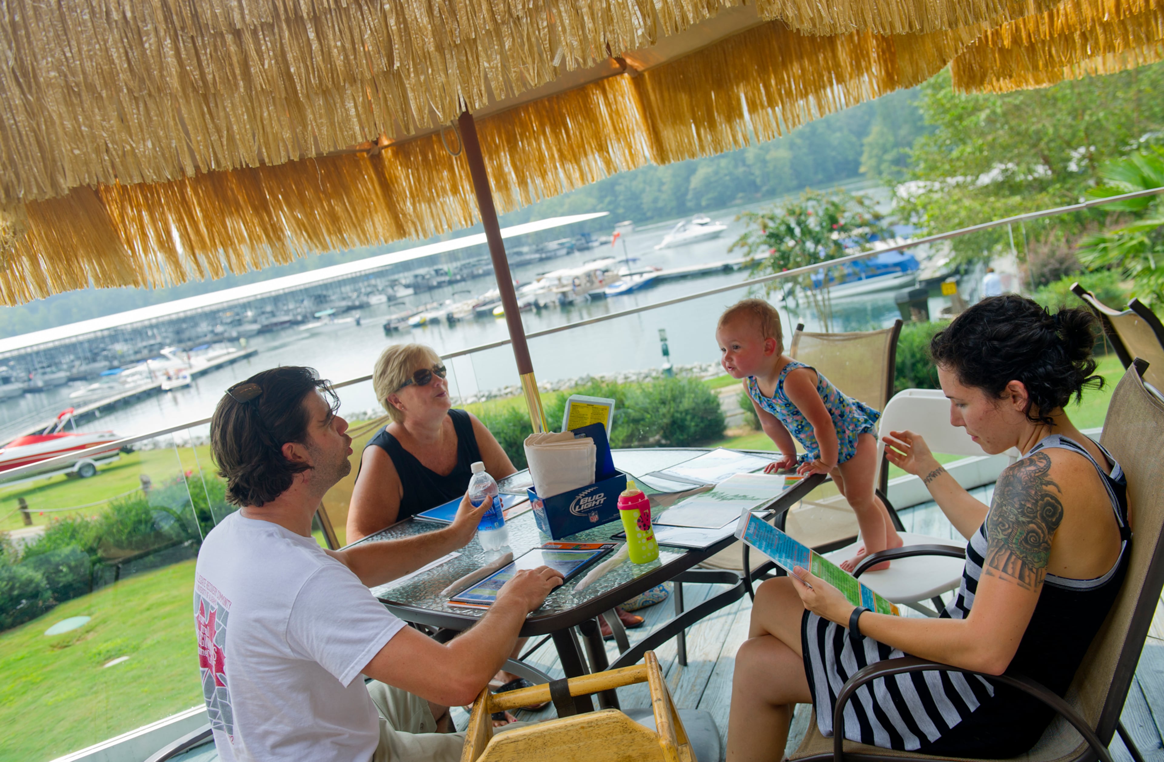 Brett Bagley (left), his mother Jill, daughter Lucy, and wife Andrea decide what to eat for lunch at Fish Tales Lakeside Grille in Flowery Branch on Sunday.