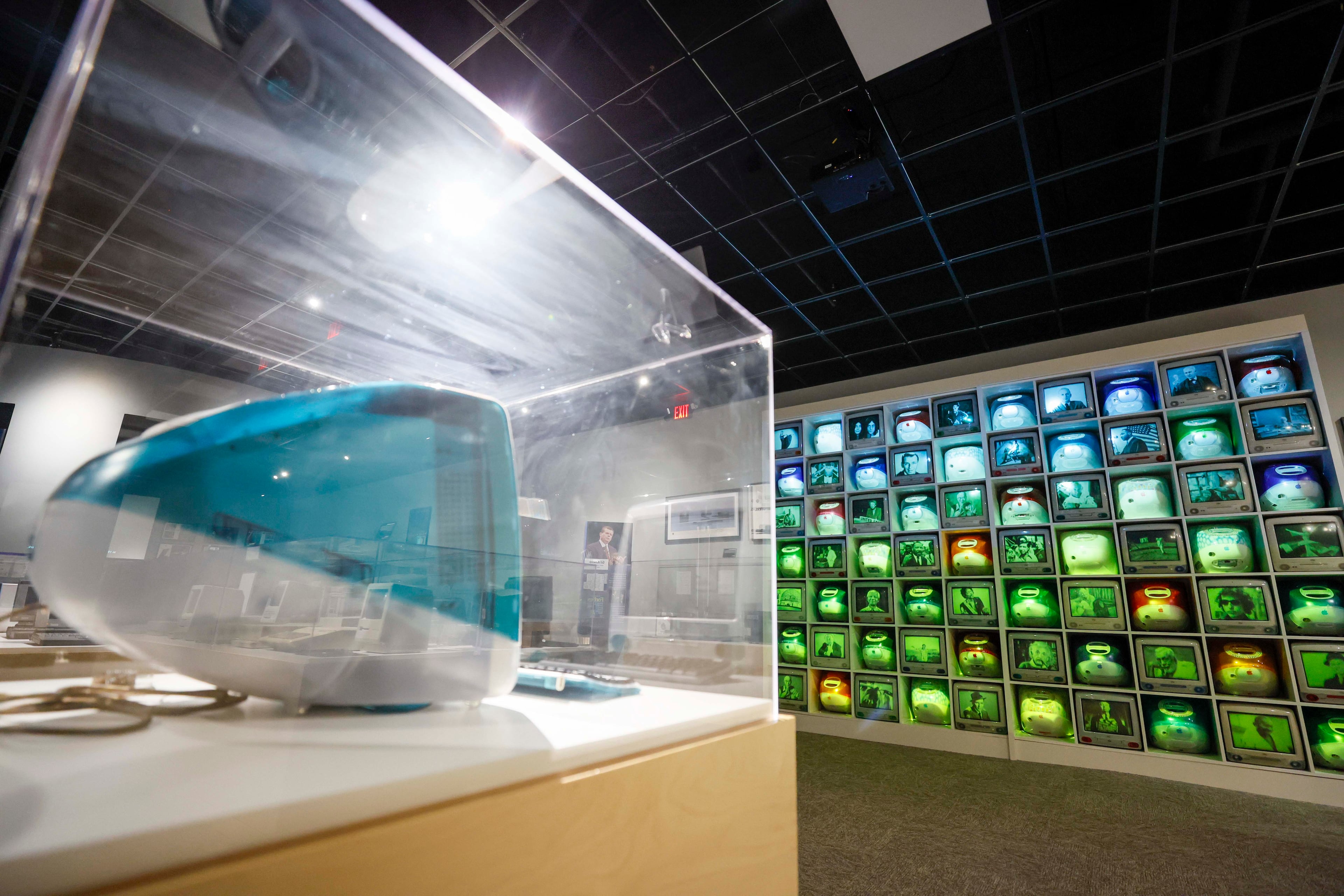 The very first iMac G3, introduced in 1998 in Bondi Blue, is shown in The Age of i Hall at the "50 Years of Innovation from Apple" exhibit at the Mimms Museum on Sunday, April 19, 2026, in Roswell. (Miguel Martinez/AJC)