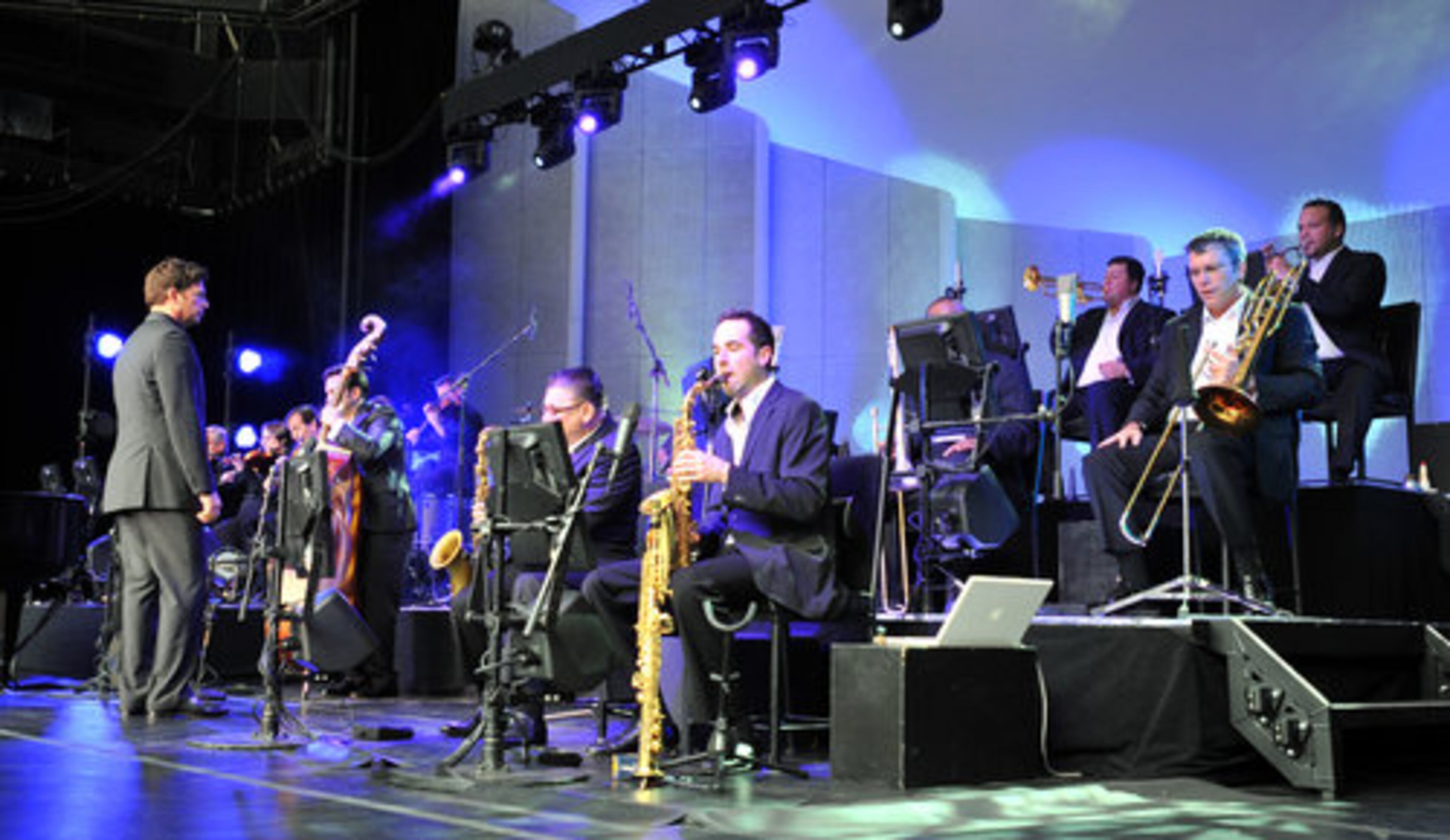 Harry Connick Jr. (left) listens the rhythm of his orchestra during his concert at Atlanta's Chastain Park Amphitheatre Saturday night. Saturday, June 19, 2010.