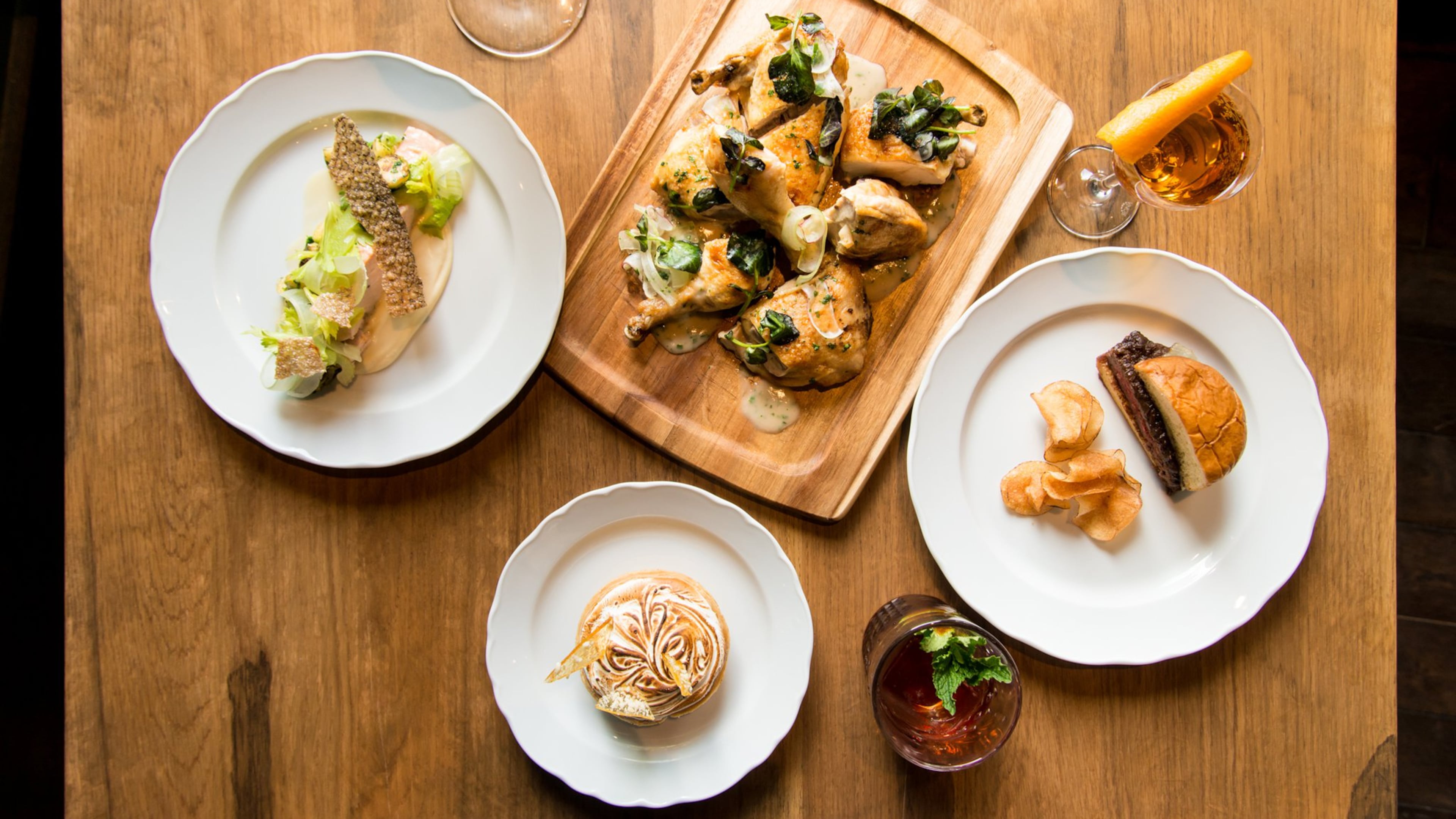 Achie's Poached Salmon, Spatch-Cocked Chicken, Wagyu Burger, and Lime Chess Pie with a trio of cocktails. Photo credit- Mia Yakel.