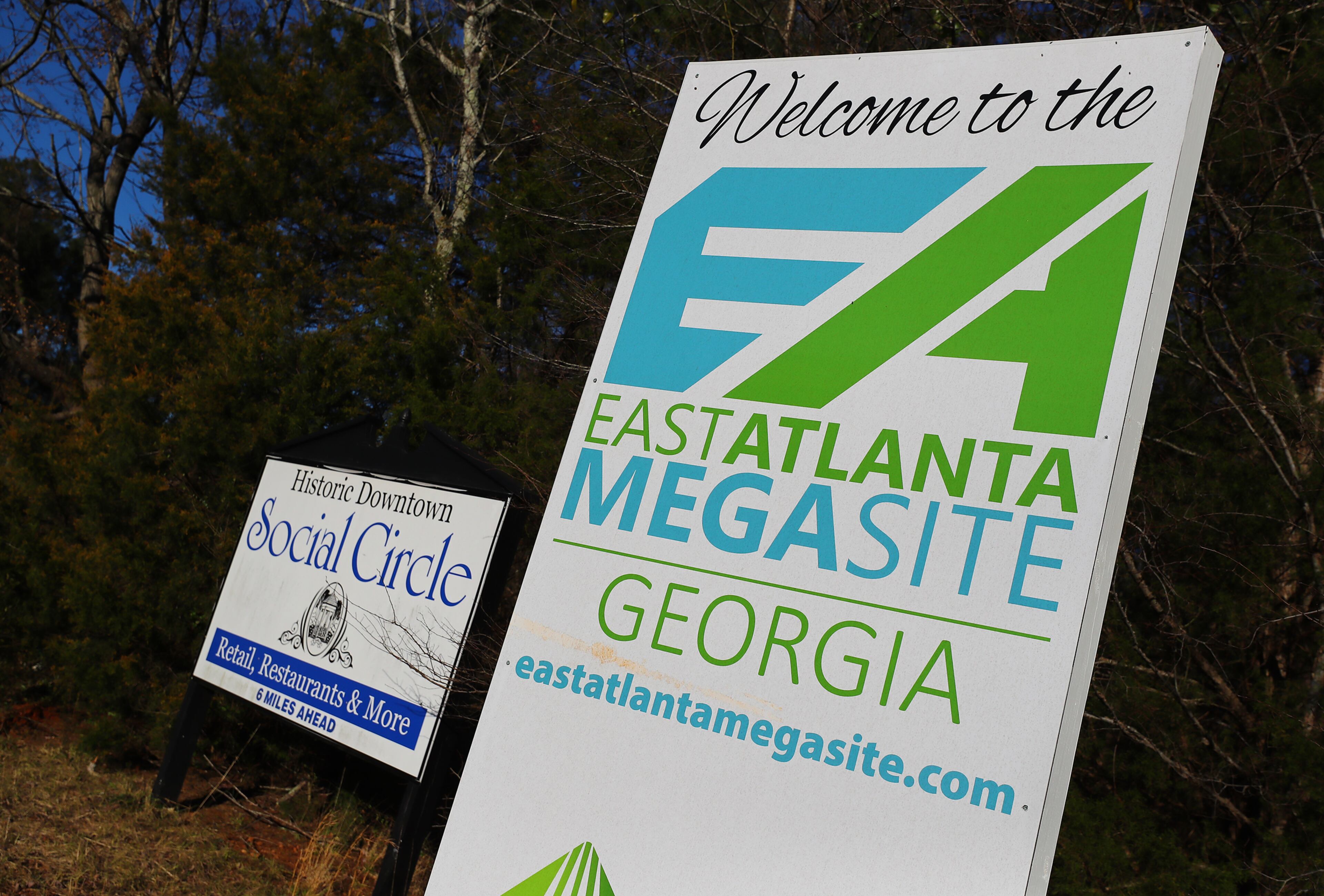 011822 Social Circle: A East Atlanta Megasite sign marking the Rivian project site sits next to a historic downtown Social Circle sign at the Stanton Springs exit in Newton County at I-20 on Tuesday, Jan. 18, 2022, in Social Circle. The Rivian project excites developers and local leaders, but many nearby residents are apprehensive. “Curtis Compton / Curtis.Compton@ajc.com”`