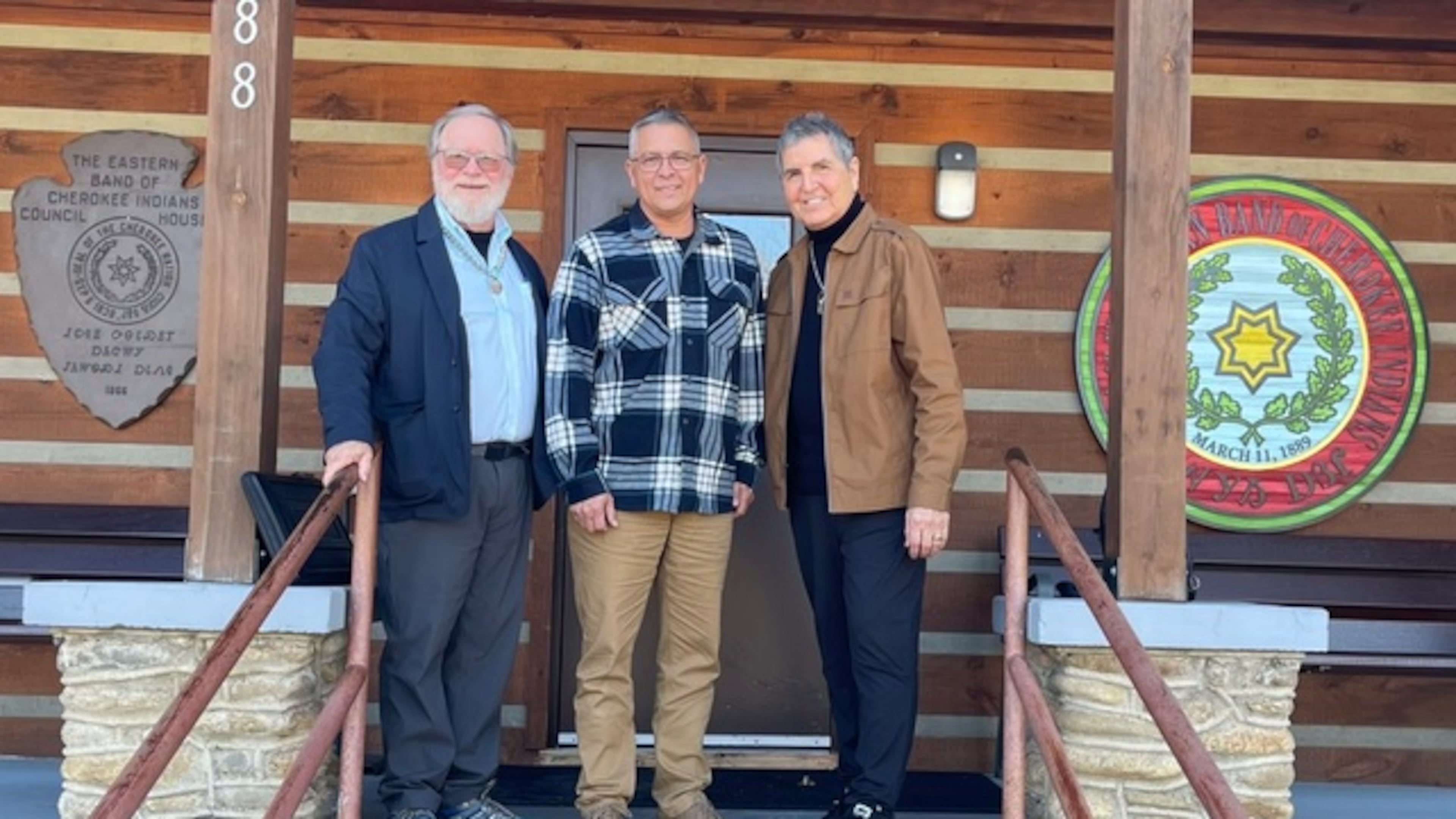 Robert Wilson, left, and Clifton Chippewa, right, stand with Michell Hicks, the principal chief of the Eastern Band of Cherokee Indians.