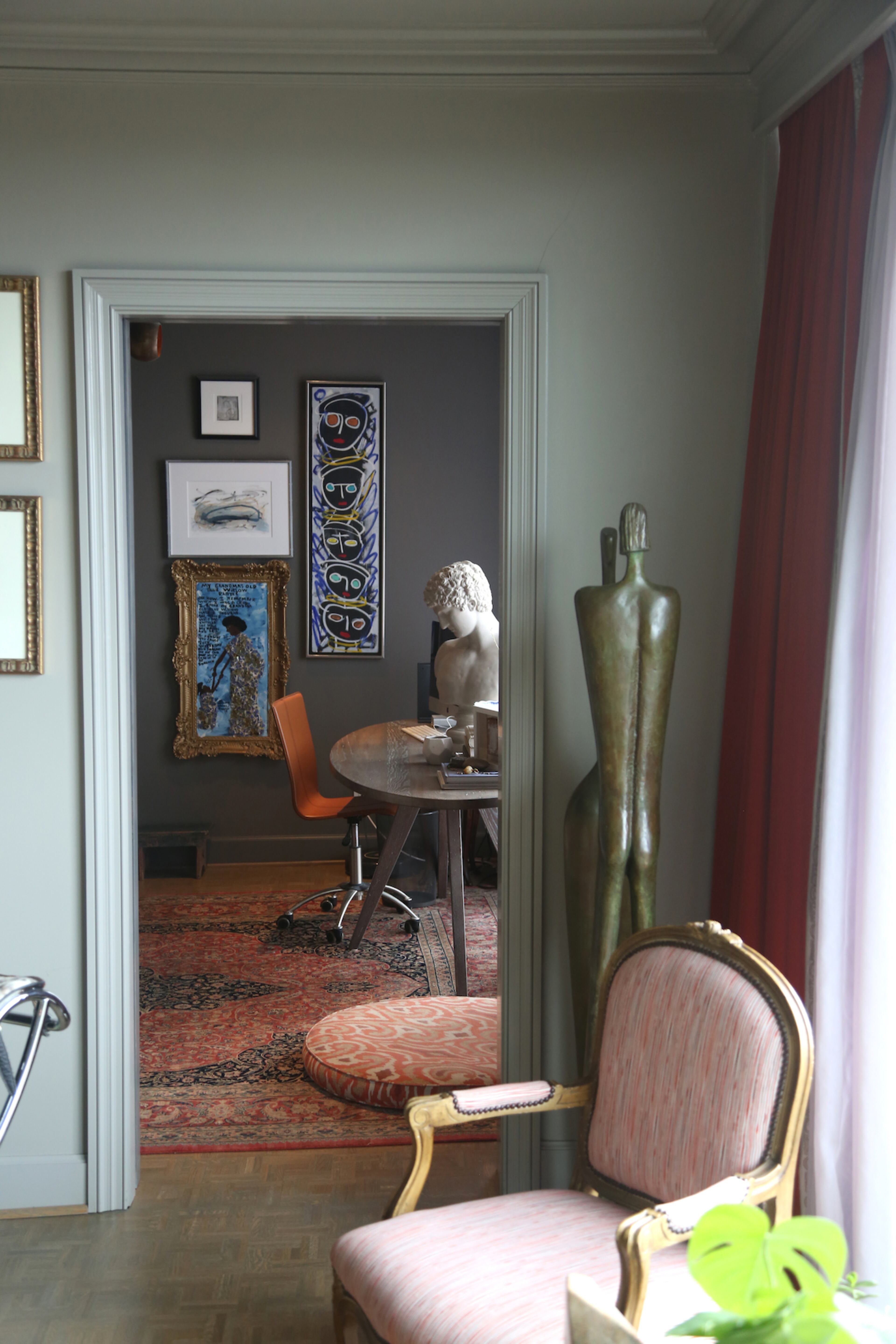 Art and sculpture, such as a piece by Aharon Bezalel, and ocher tones are found throughout the Buckhead condo.