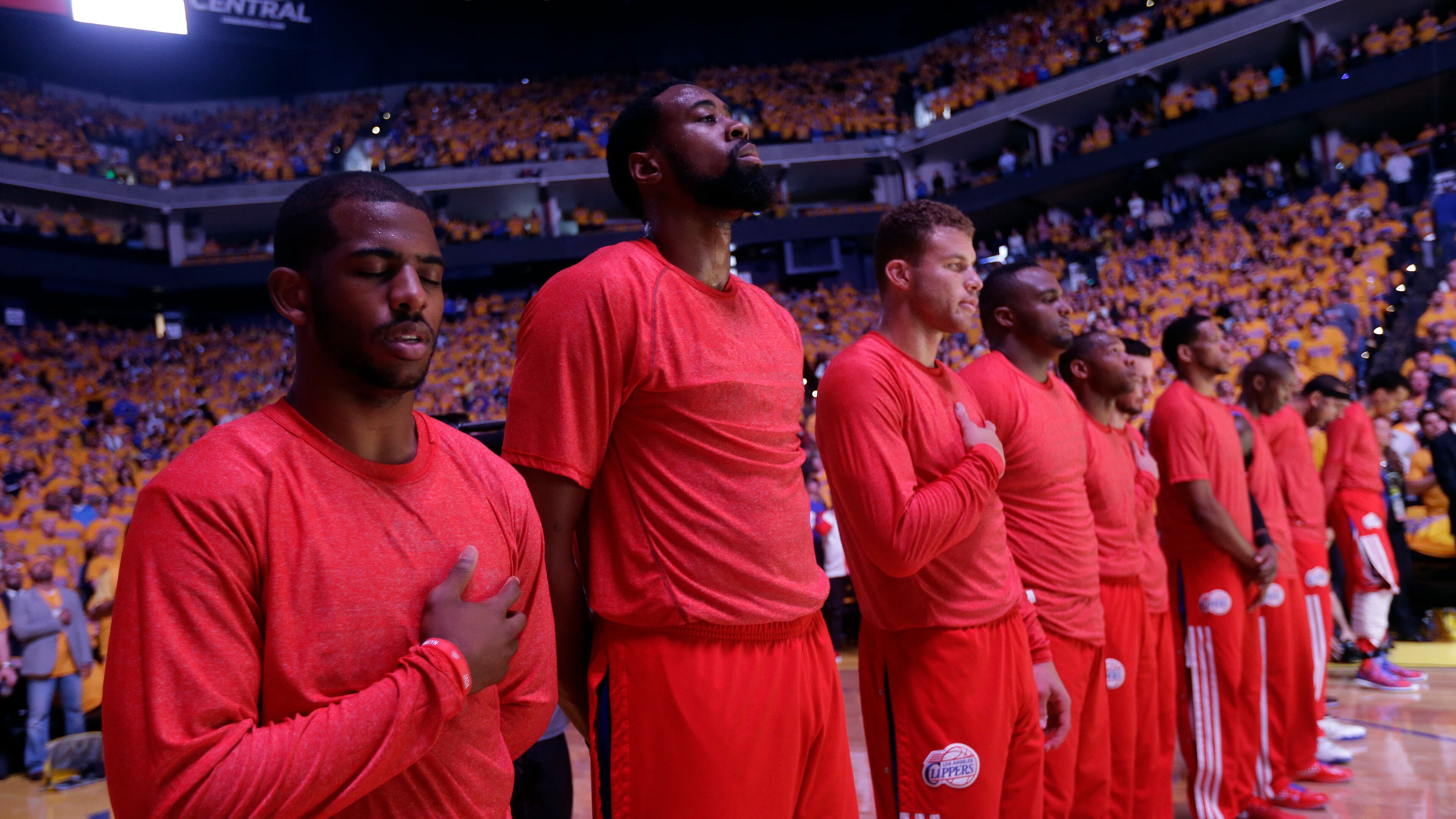 Los Angeles Clippers players listen to the national anthem wearing their warmup jerseys inside out to protest alleged racial remarks by team owner Donald Sterling before Game 4 of an opening-round NBA basketball playoff series against the Golden State Warriors on Sunday, April 27, 2014, in Oakland, Calif. (AP Photo/Marcio Jose Sanchez) Clippers players wore their warmup jerseys inside out during the national anthem Sunday to protest alleged racial remarks by team owner Donald Sterling. (AP photo)
