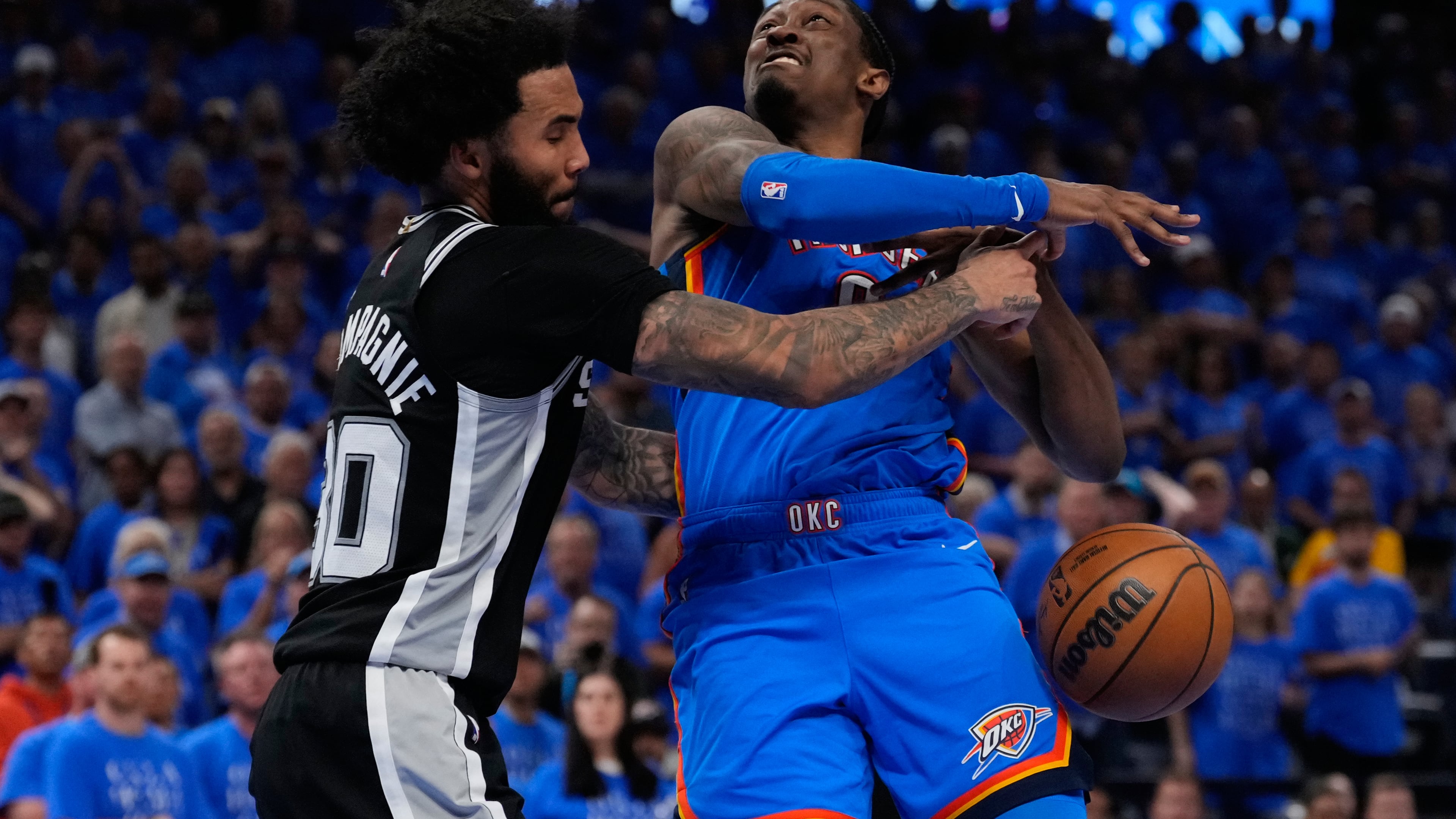 San Antonio Spurs forward Julian Champagnie (30) defends against Oklahoma City Thunder guard Jalen Williams (8) during overtime of Game 1 in a third-round NBA basketball playoffs series Monday, May 18, 2026, in Oklahoma City. (AP Photo/Tony Gutierrez)