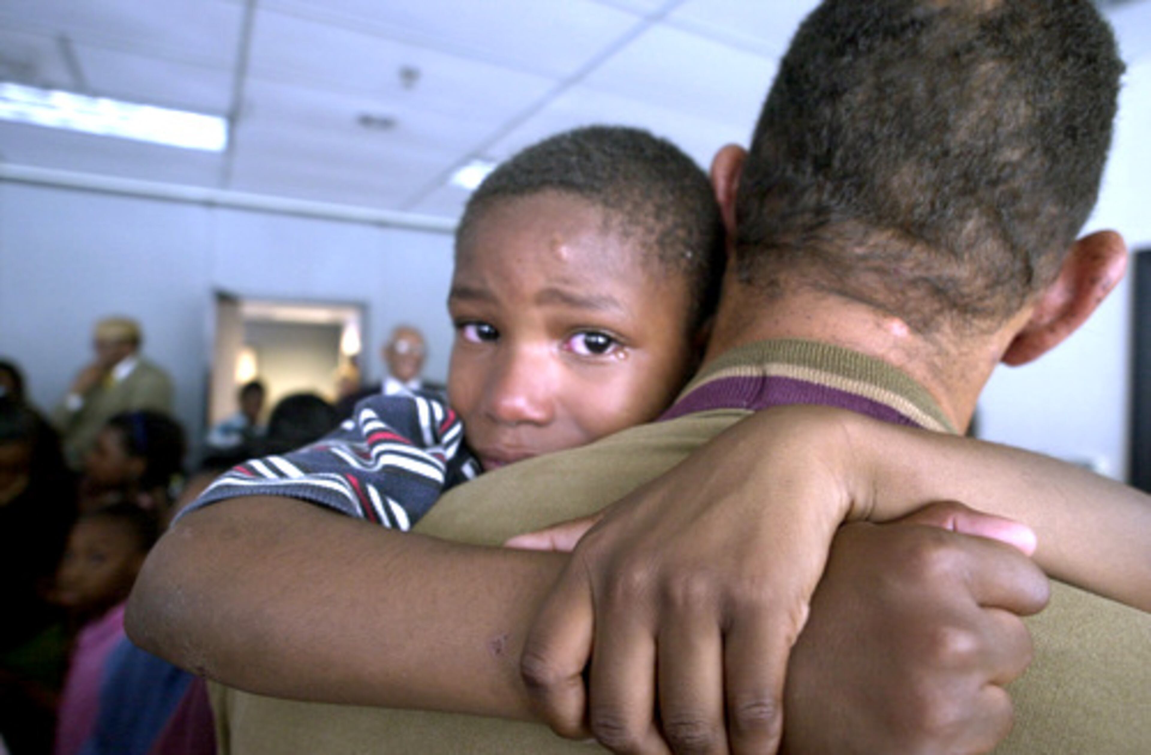 Stephen Duncan hugs his dad for the first time in months as a tiny tear forms in his eye. (W.A. BRIDGES/FILE)