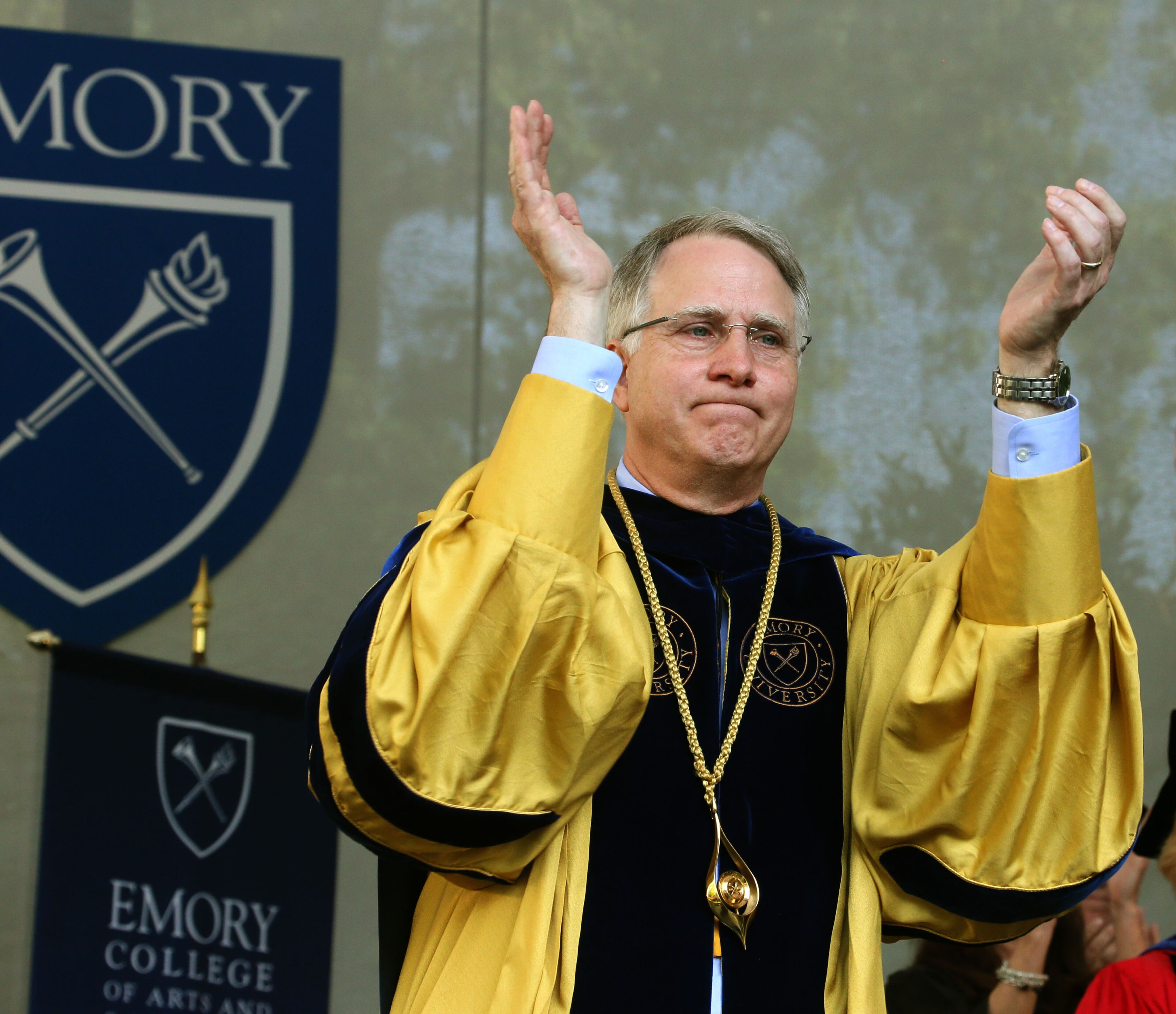 Emory President James W. Wagner applauds the graduates at the close of the ceremony. U.S. Rep. and Civil Rights leader John Lewis was the keynote speaker at Emory University's 2014 spring commencement, Emory's 169th. 15,000 people were expected to attend. BOB ANDRES / BANDRES@AJC.COM