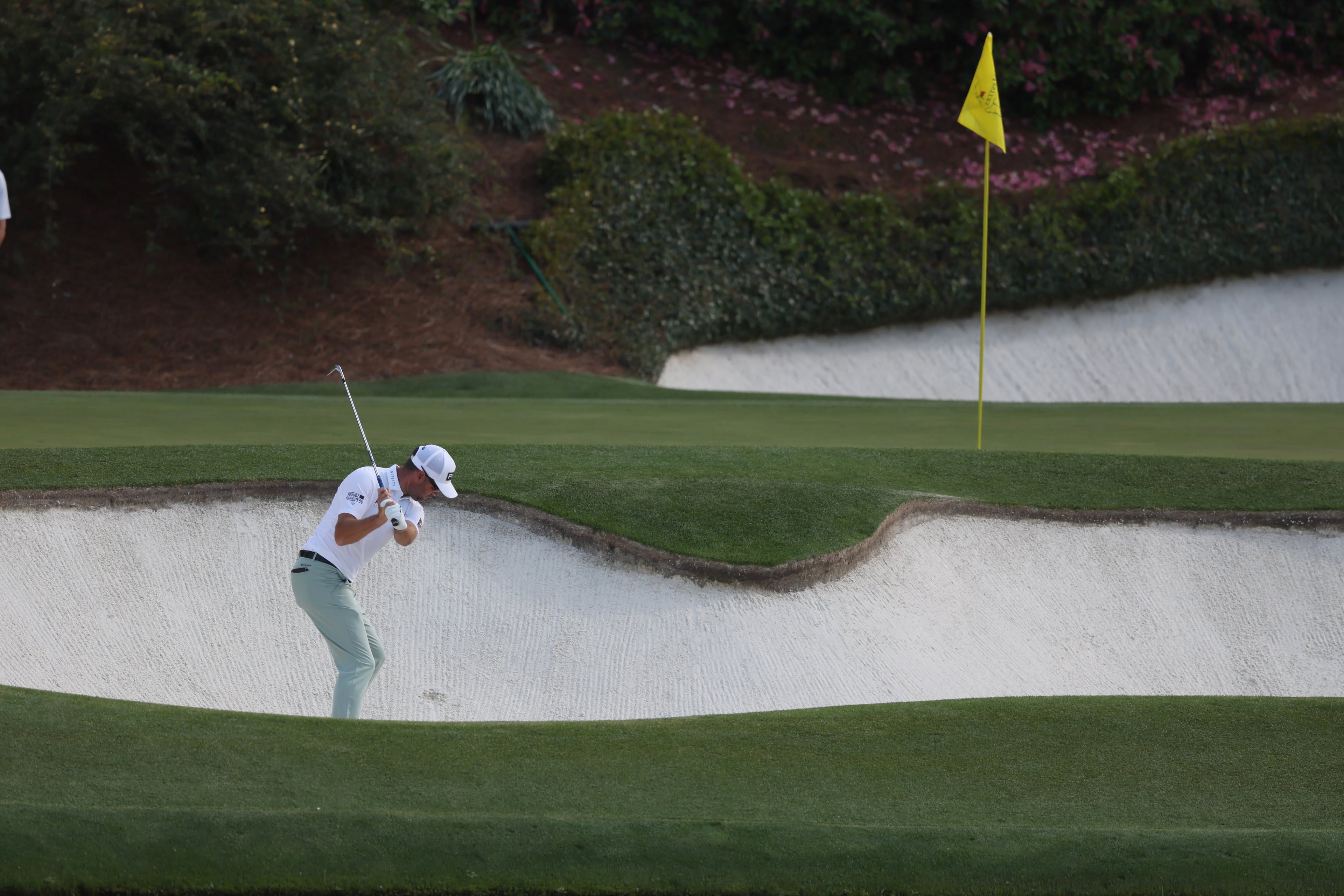 Corey Conners hits out of bunker on 12th hole during third round of the Masters golf tournament, at Augusta National Golf Club, Saturday, April 12, 2025, in Augusta, Ga. (Jason Getz / AJC)