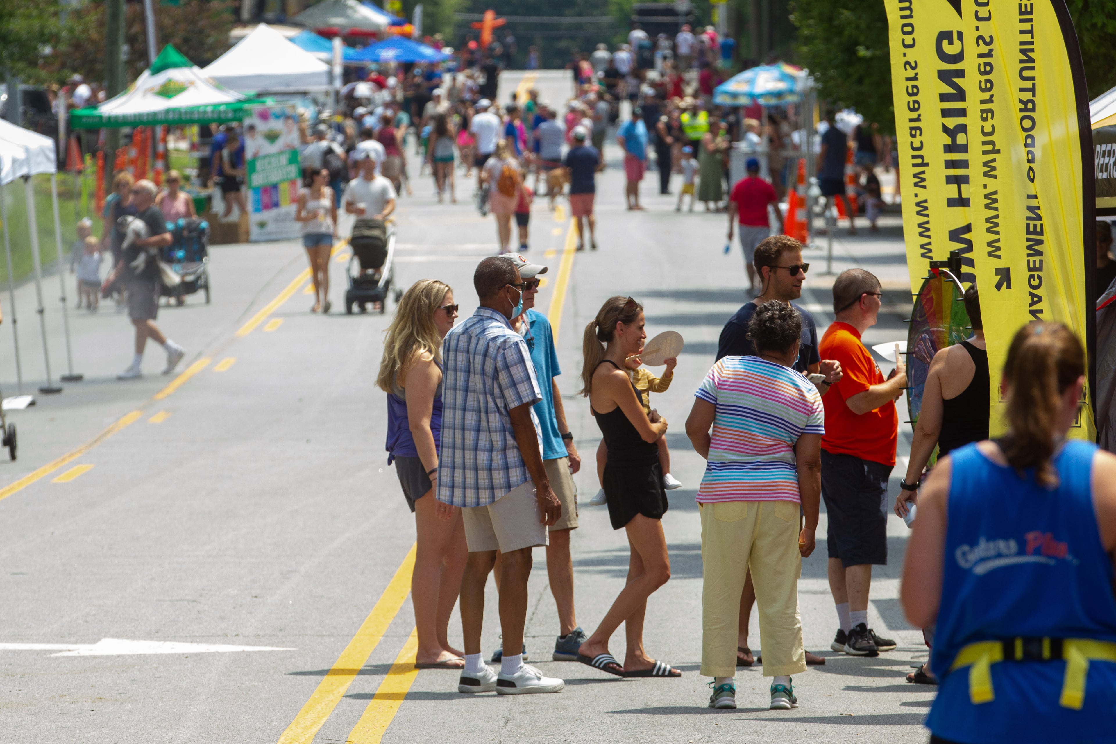 People look over the vendor tents along Dresden Drive during the Brookhaven Cherry Blossom Festival on Saturday, July 31, 2021. STEVE SCHAEFER FOR THE ATLANTA JOURNAL-CONSTITUTION