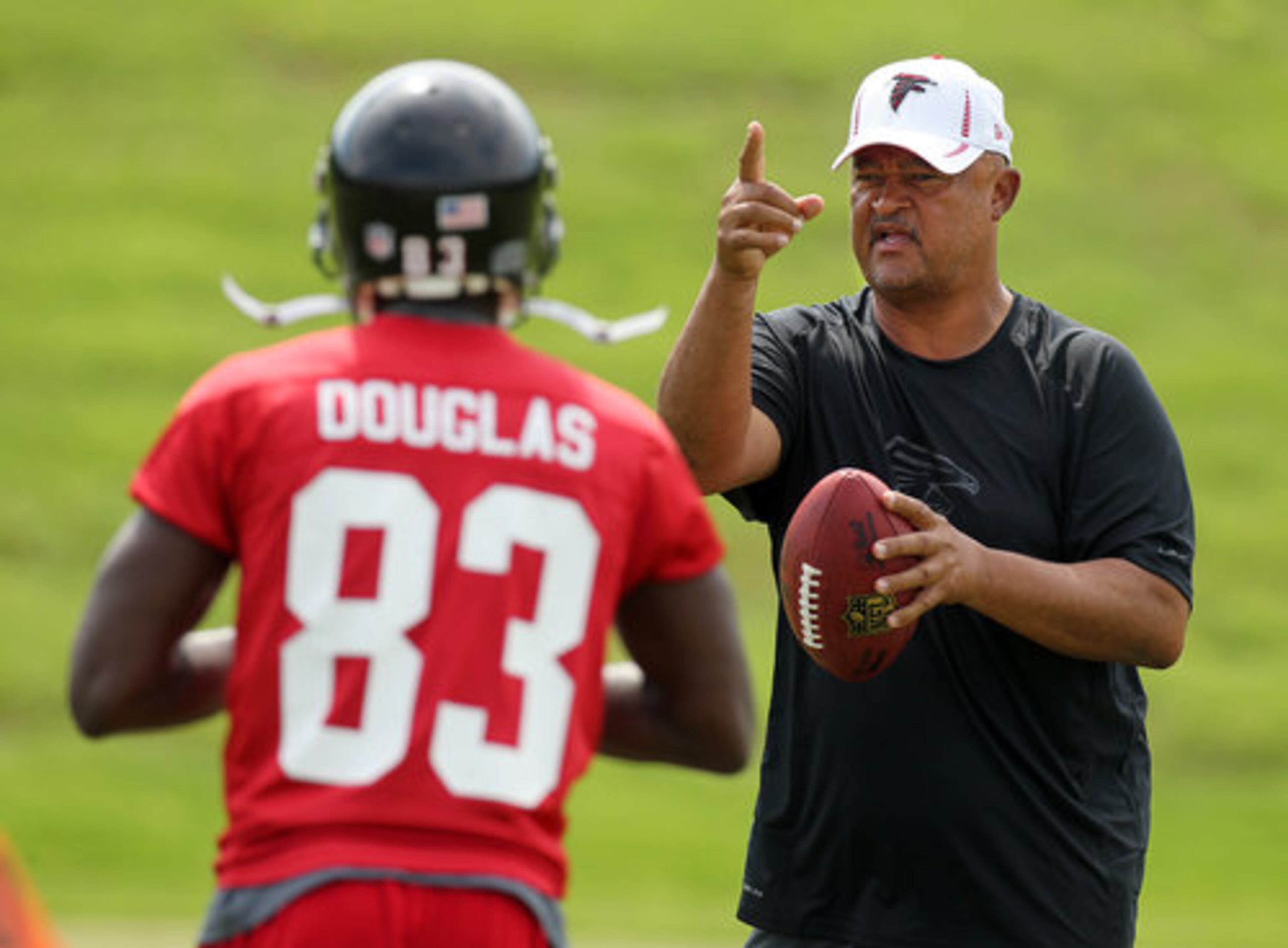Falcons wide receivers coach Terry Robiskie discusses a drill with wide receiver Harry Douglas.