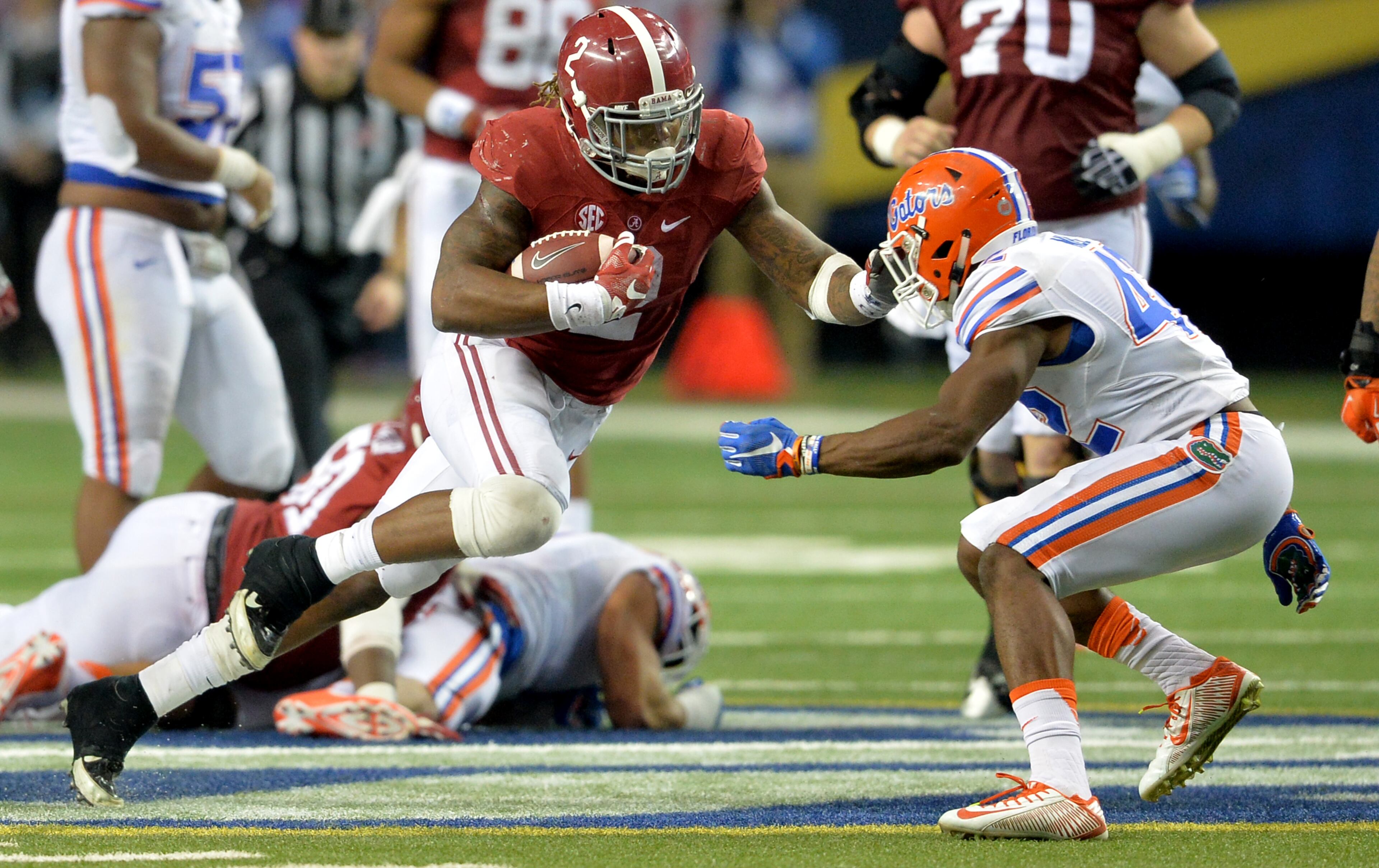 December 5, 2015 Atlanta: Alabama Crimson Tide running back Derrick Henry looks for running room against Florida during the SEC Championship at the Georgia Dome Saturday December 5, 2015. Henry broke the SEC record for the most rushing yards in a single season, previously held by legendary Georgia Bulldogs running back Herschel Walker. BRANT SANDERLIN/BSANDERLIN@AJC.COM