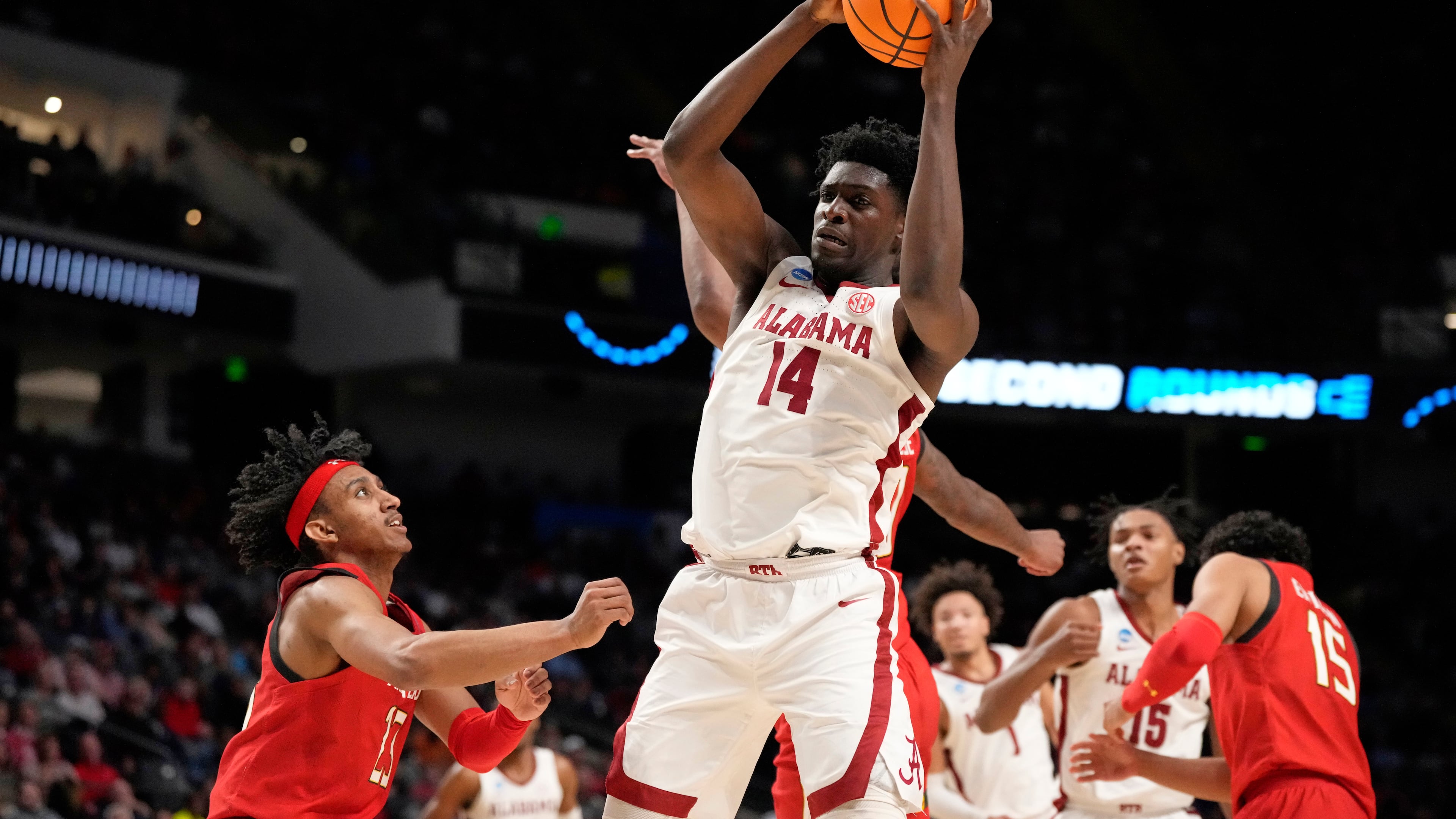 FILE - Alabama center Charles Bediako (14) pulls down a rebound while guarded by Maryland guard Ian Martinez, left, during the second half of a second-round college basketball game in the men's NCAA Tournament in Birmingham, Ala., March 18, 2023. (AP Photo/Rogelio V. Solis, File)