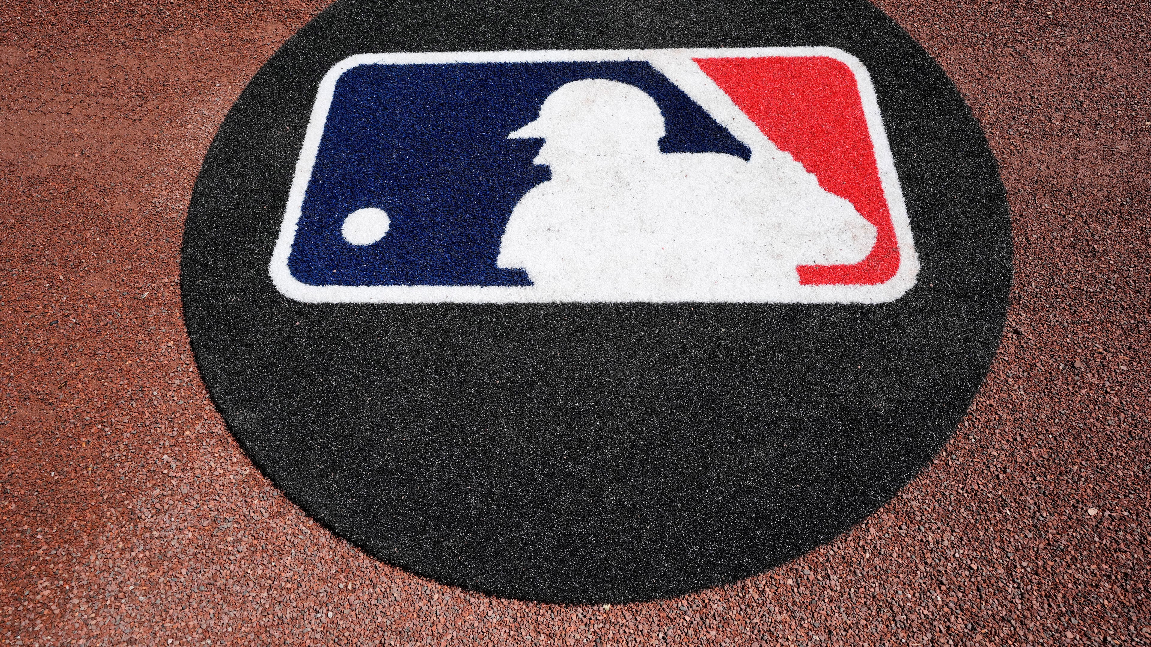 FILE - THe Major League Baseball logo is seen on the field before a spring training baseball game between the Pittsburgh Pirates and the Atlanta Braves Tuesday, Feb. 27, 2024, in Bradenton, Fla. (AP Photo/Charlie Neibergall, File)