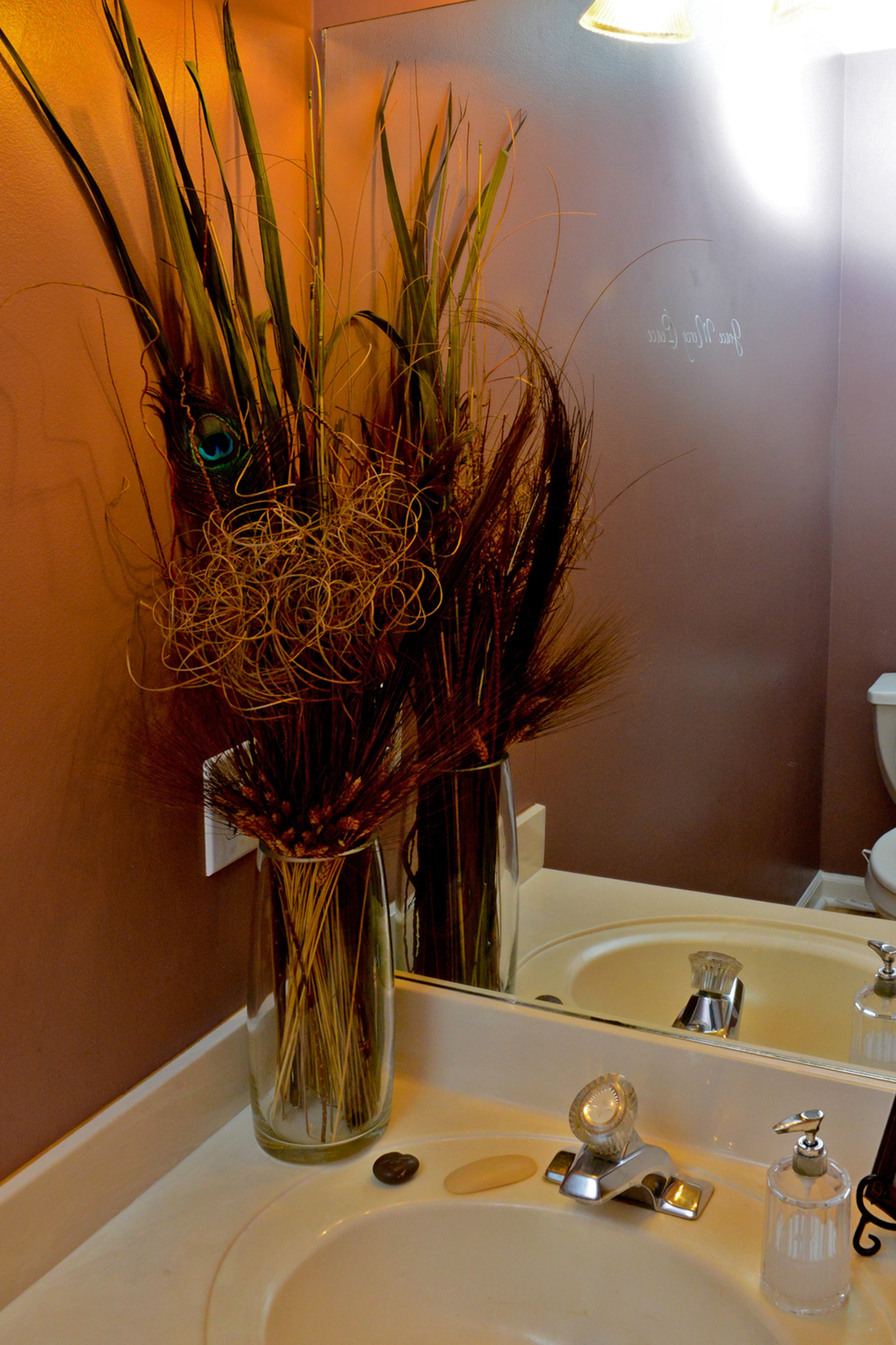 In her powder room on the main level, artwork inspired the decor for the entire space, including the Behr Blackberry Mocha paint color on the walls.