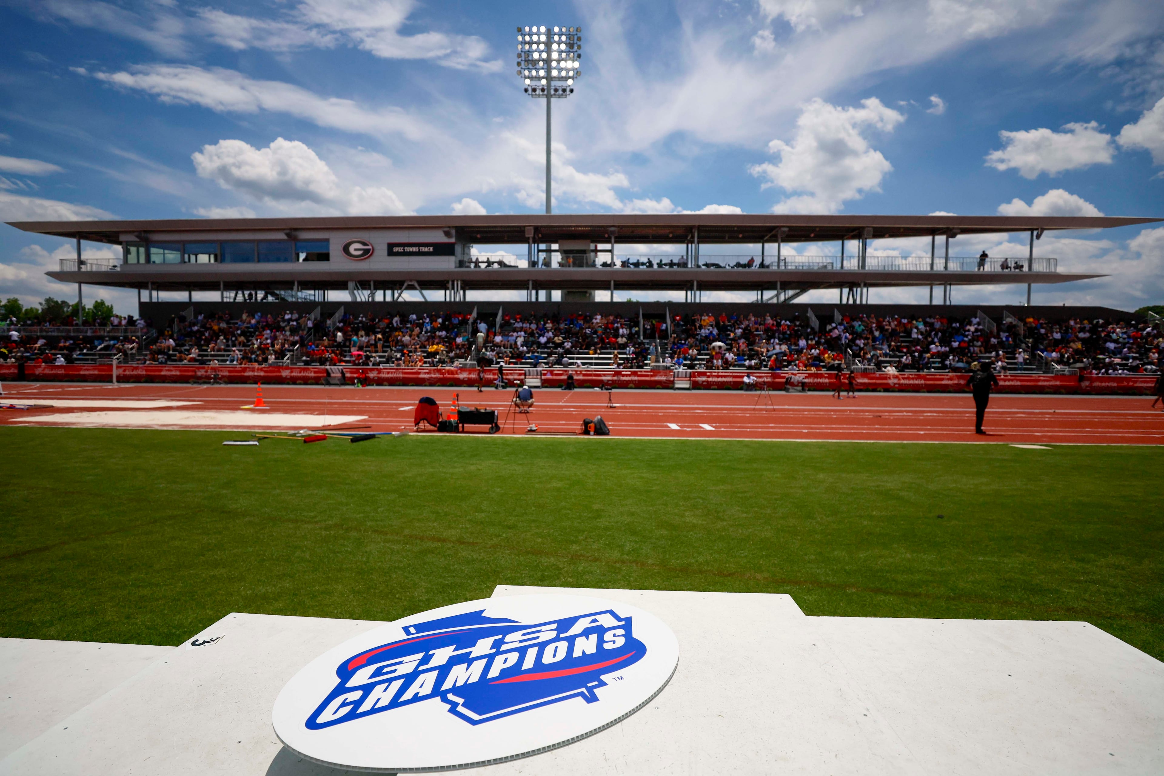 A GHSA logo is seen on the athletes’ podium during the Boys 1600-meter Run 1A Division 2 at the GHSA track and field state championships at UGA Spec Towns Track on Monday, May 11, 2026, in Athens.
(Miguel Martinez/AJC)