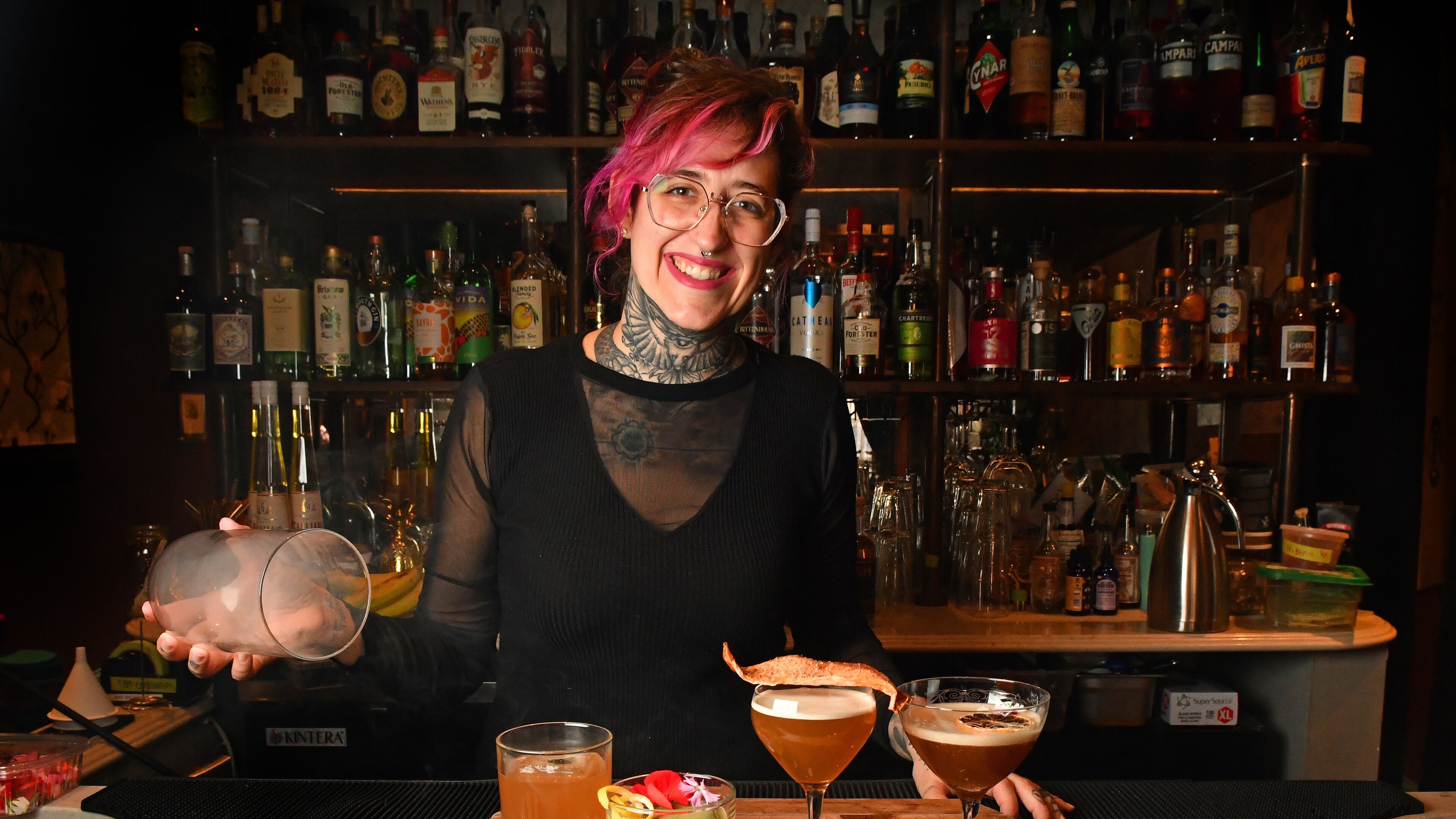 Flemming Love, mixologist at Southern Belle and Georgia Boy, performs the final stage, a smoke dome, on a nonalcoholic cocktail called Modern Yesterdays (left); also shown: At Dusk or Dawn, Southern Sentiments, and Dear Diary (far right). (Styling by Flemming Love / Chris Hunt for the AJC)